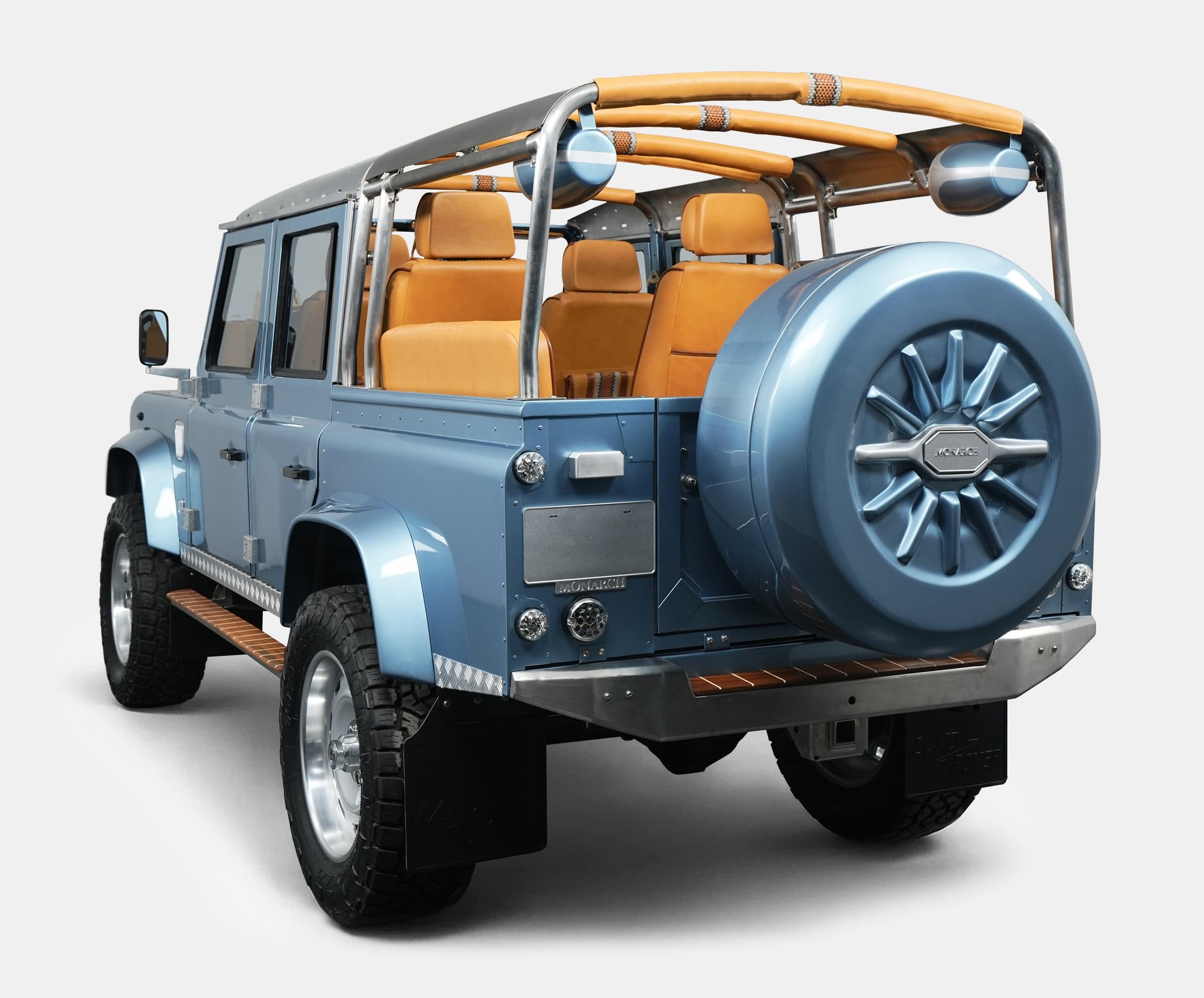 Custom Land Rover Defender in blue with tan interior and roll bar