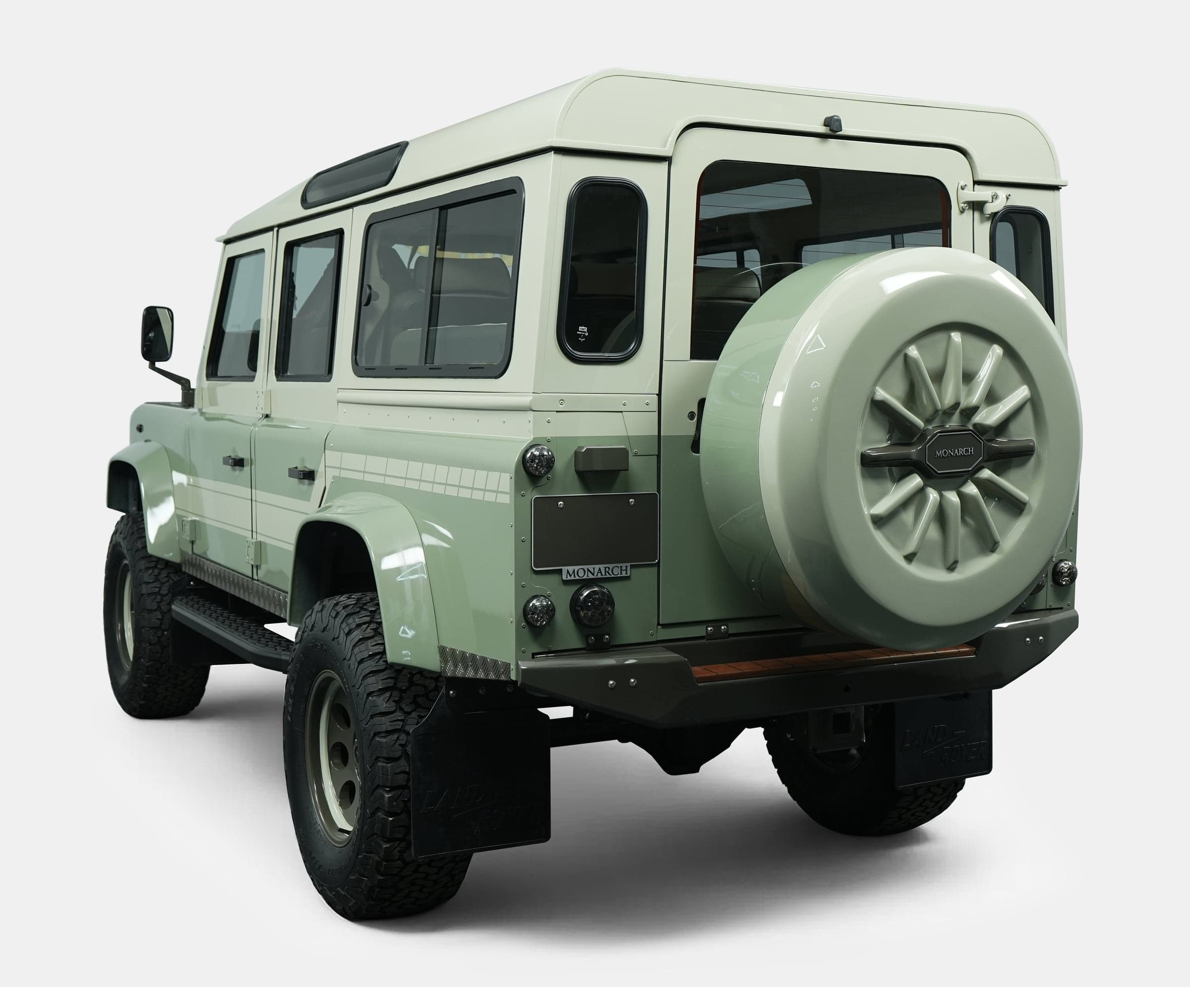Rear view of a bespoke Land Rover Defender in light green with custom features