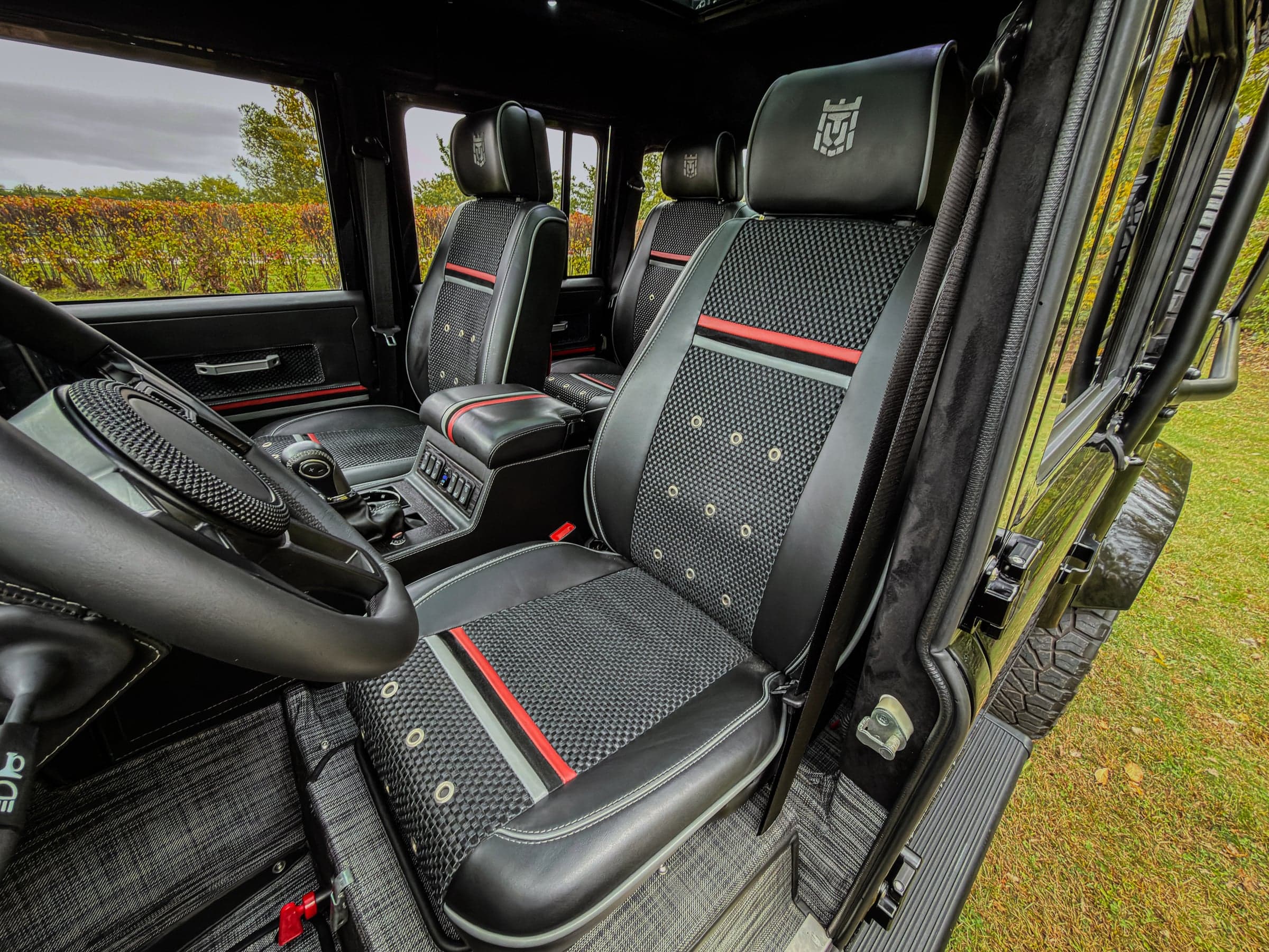 Luxury interior of a custom Land Rover Defender with intricate seat design and high-quality materials