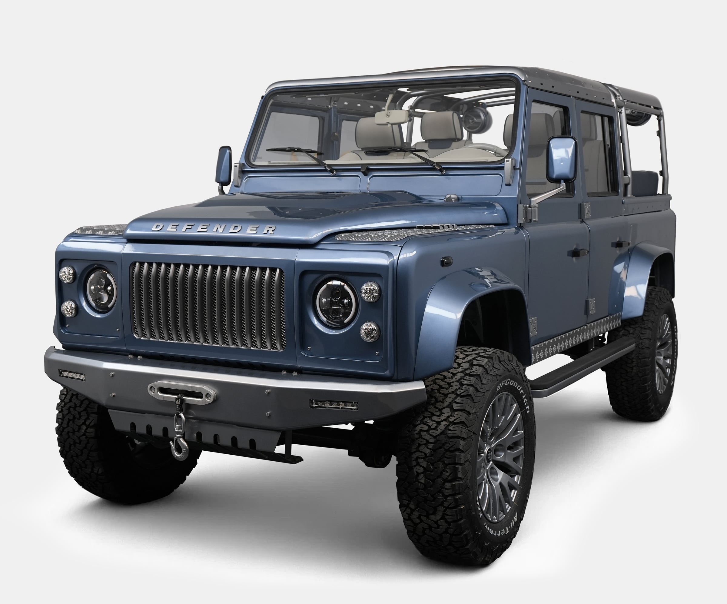 Custom Land Rover Defender in blue with premium wheels and off-road tires