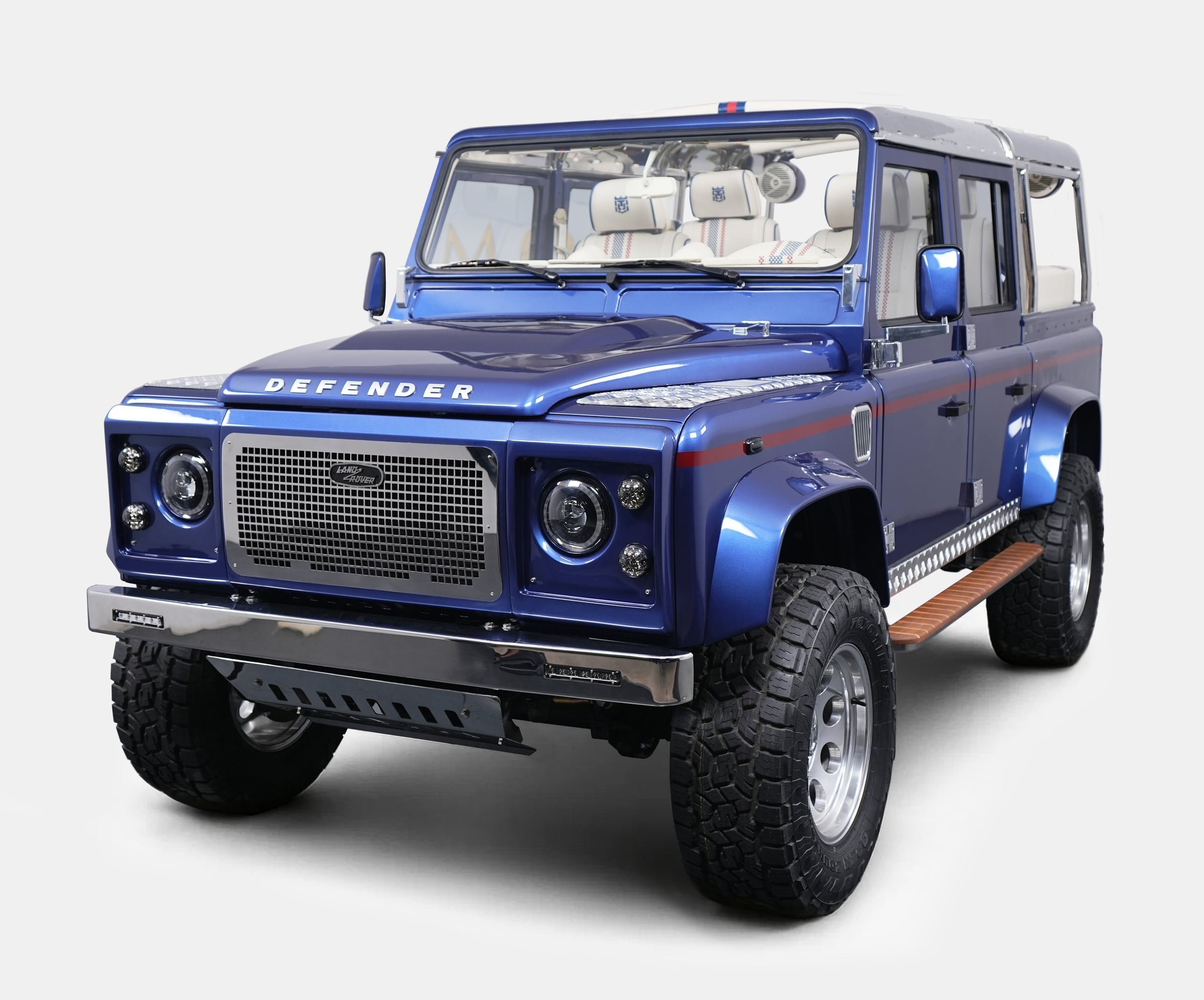 Custom blue Land Rover Defender with luxury details and off-road capabilities
