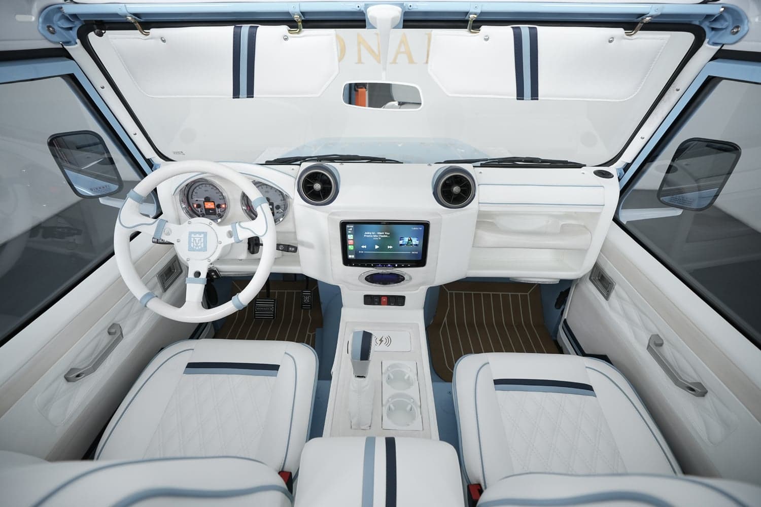 Interior Shot: Luxurious Cabin Design Bespoke Land Rover Defender interior featuring white and light blue leather upholstery