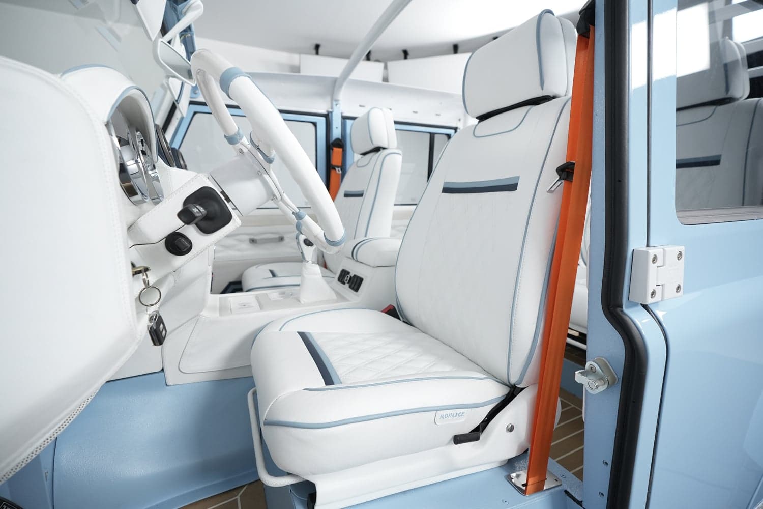 Interior Shot: Luxe Seating Design Interior view of a luxury Land Rover Defender with white and blue leather seats