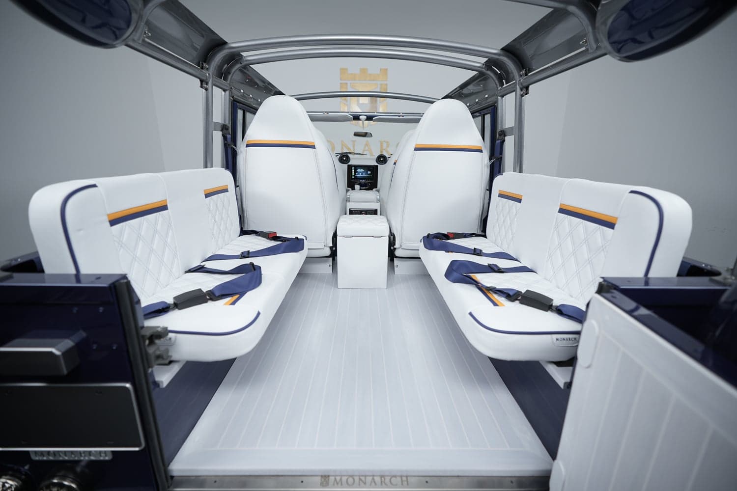 Interior Shot: Luxury Cabin Design Interior of a custom Land Rover Defender featuring white leather seats with diamond stitching and blue accents