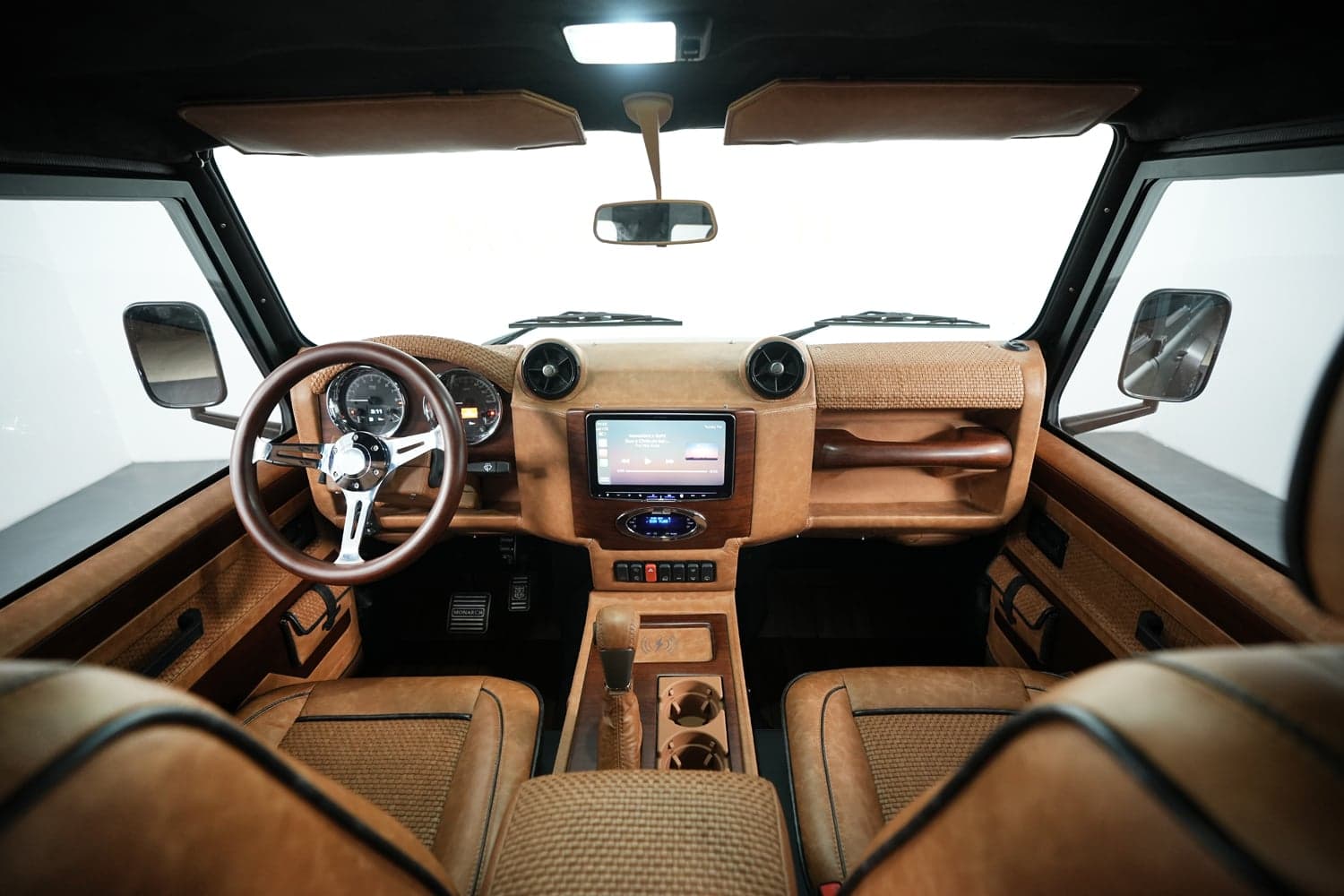Interior Shot: Luxurious Cabin Design Interior view of a bespoke Land Rover Defender showcasing premium materials and modern technology