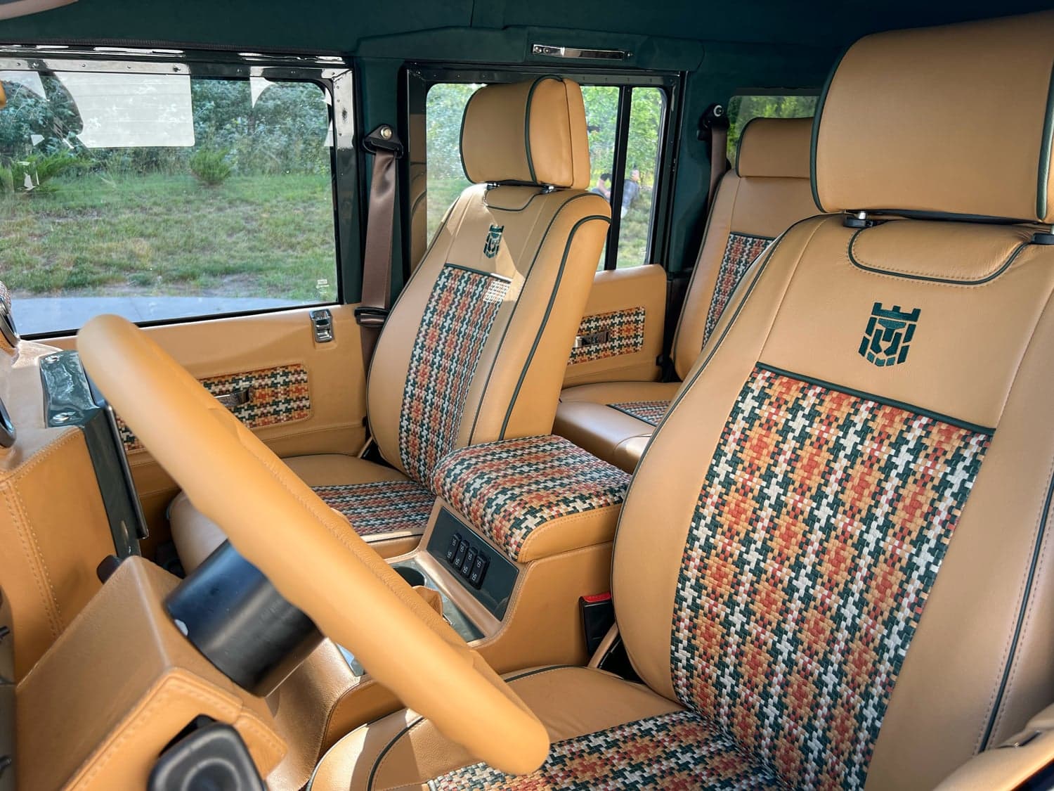 Interior Shot: Luxurious Cabin Design Luxurious Land Rover Defender interior featuring custom leather seats with unique stitching
