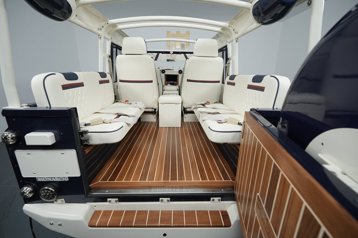 Interior Shot: Luxury Cabin Interior of a bespoke Land Rover Defender with premium white seating and wooden flooring