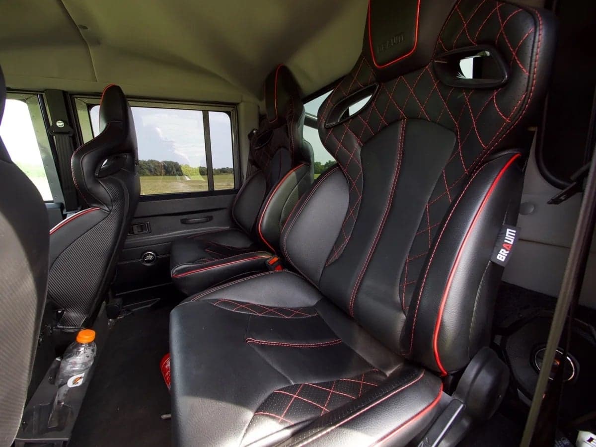 Interior Shot: Premium Custom Seating Custom leather seats with red stitching in a Land Rover Defender