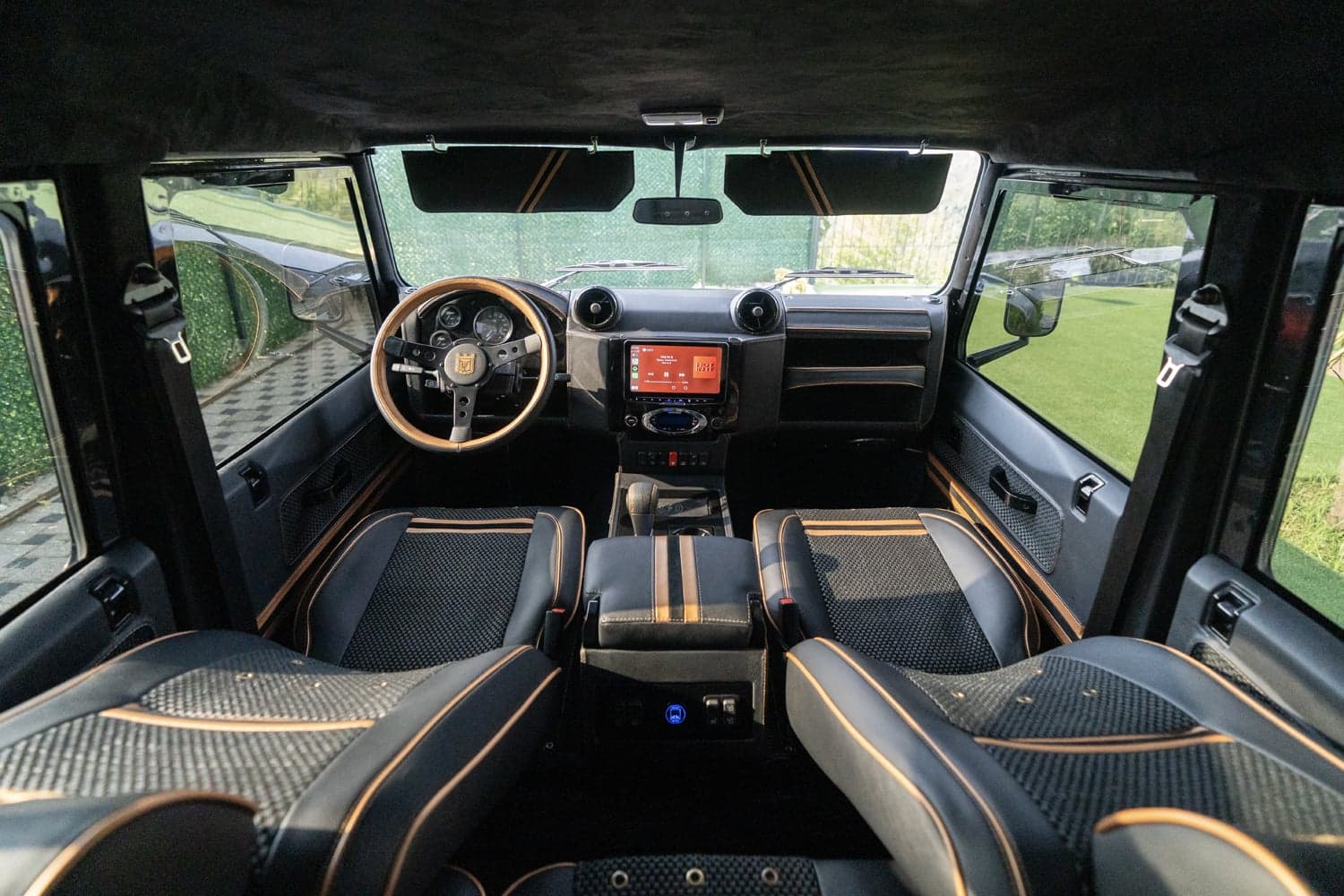 Interior Shot: Luxury Cabin Design Bespoke Land Rover Defender interior featuring premium materials and modern technology