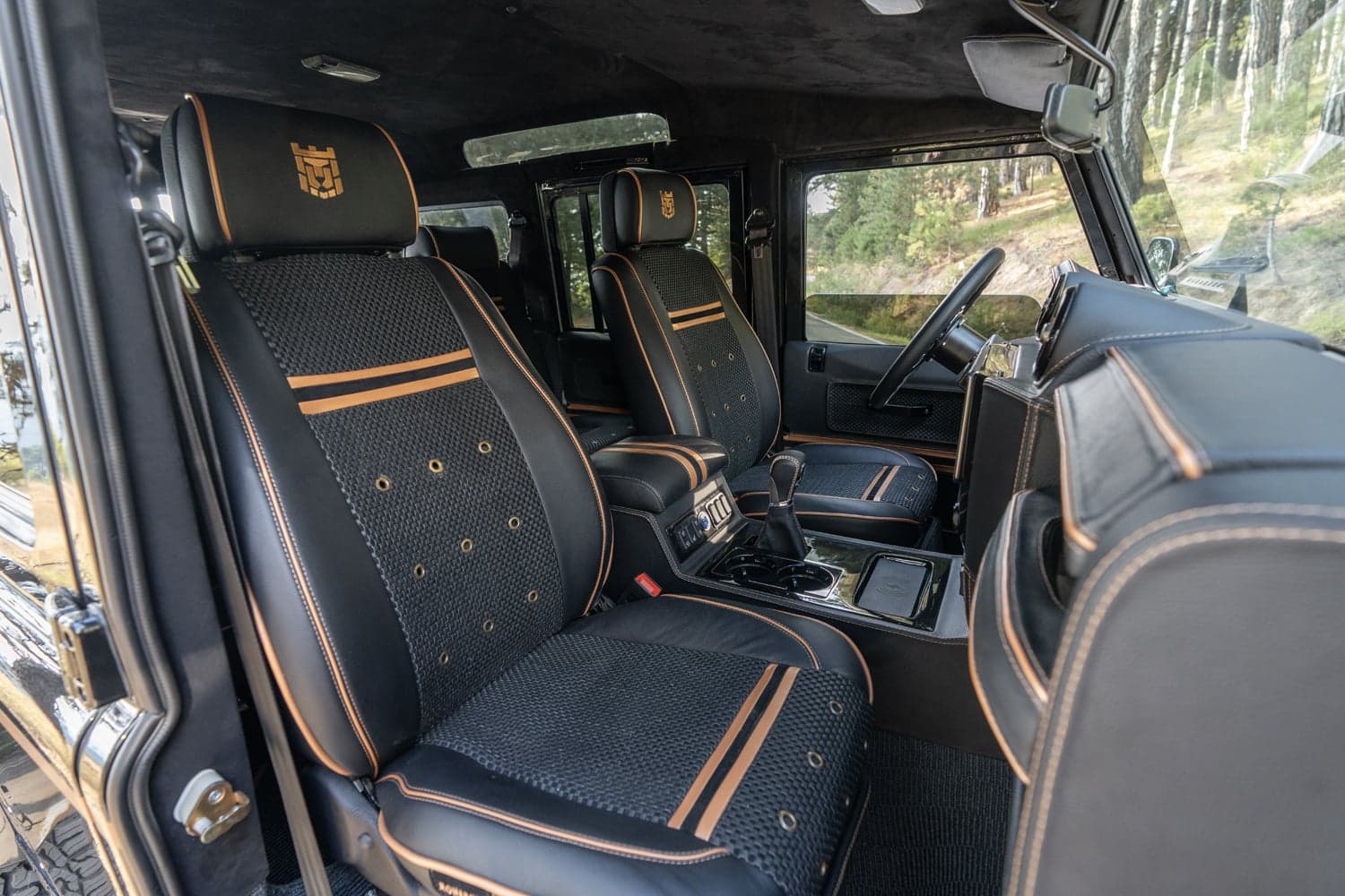 Interior Shot: Luxury Seating Bespoke Land Rover Defender interior featuring custom leather seating with orange accents