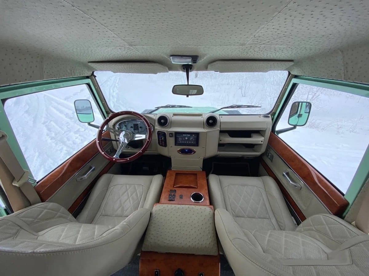 Interior Shot: Luxury Cabin Design Bespoke interior of a custom Land Rover Defender with leather seats and wood accents