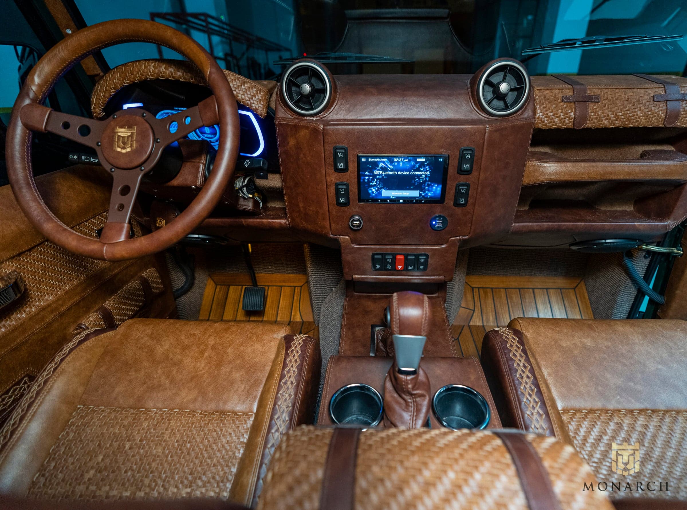 Interior Shot: Luxury Cabin Design Bespoke Land Rover Defender interior with leather upholstery and modern dashboard
