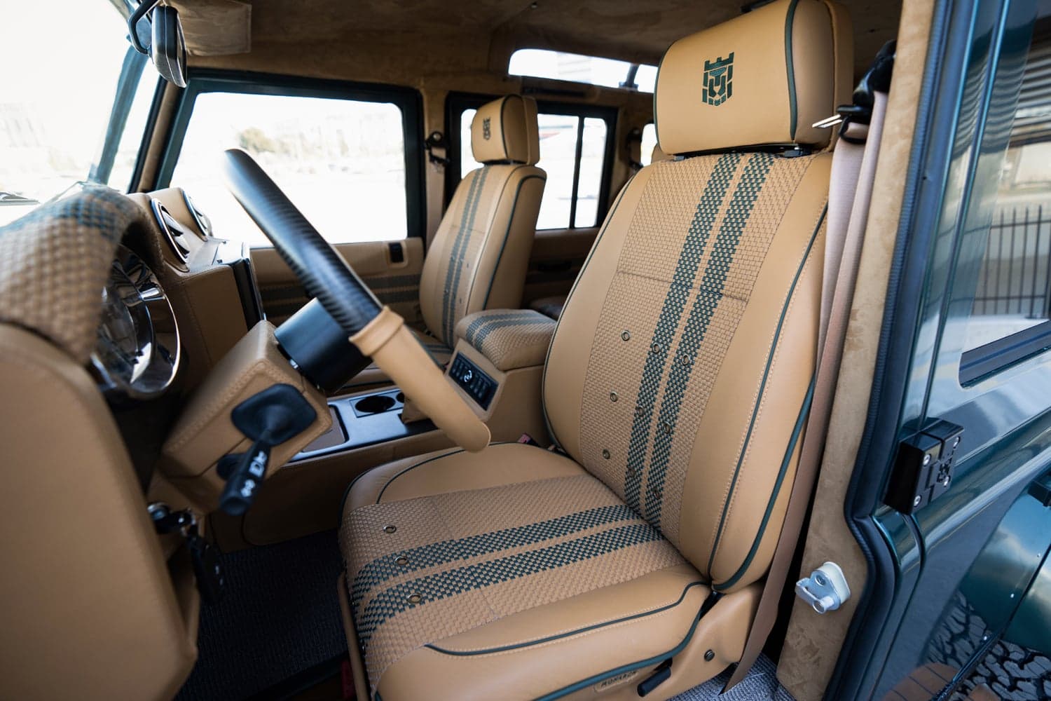 Interior Shot: Luxurious Cabin Design Luxurious interior of a custom Land Rover Defender with premium tan leather seats and a stylish dashboard
