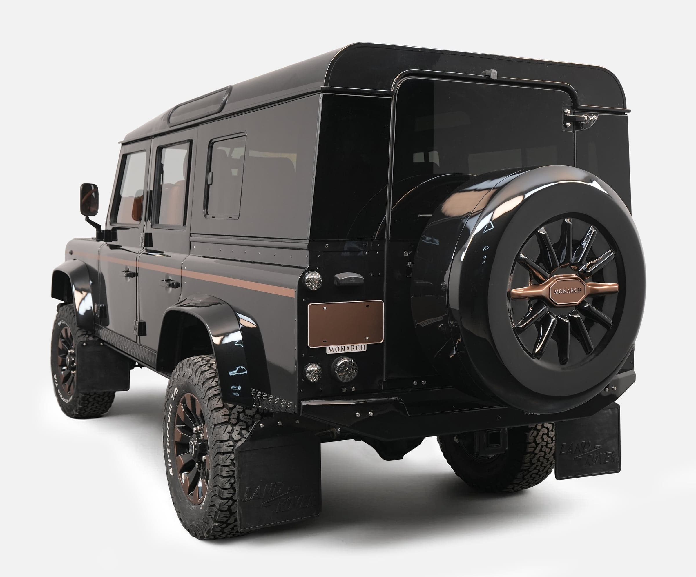 Rear View: Custom Land Rover Defender Customized black Land Rover Defender with unique styling and bronze accents