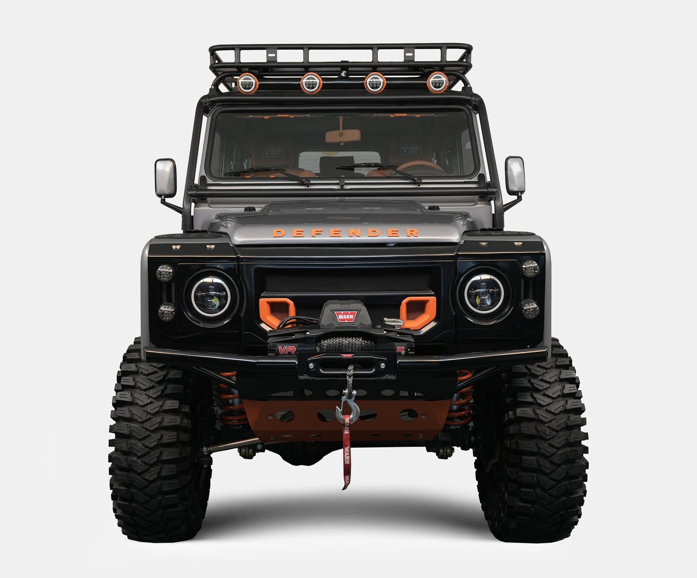 Front View: Custom Land Rover Defender Custom Land Rover Defender with black and orange accents