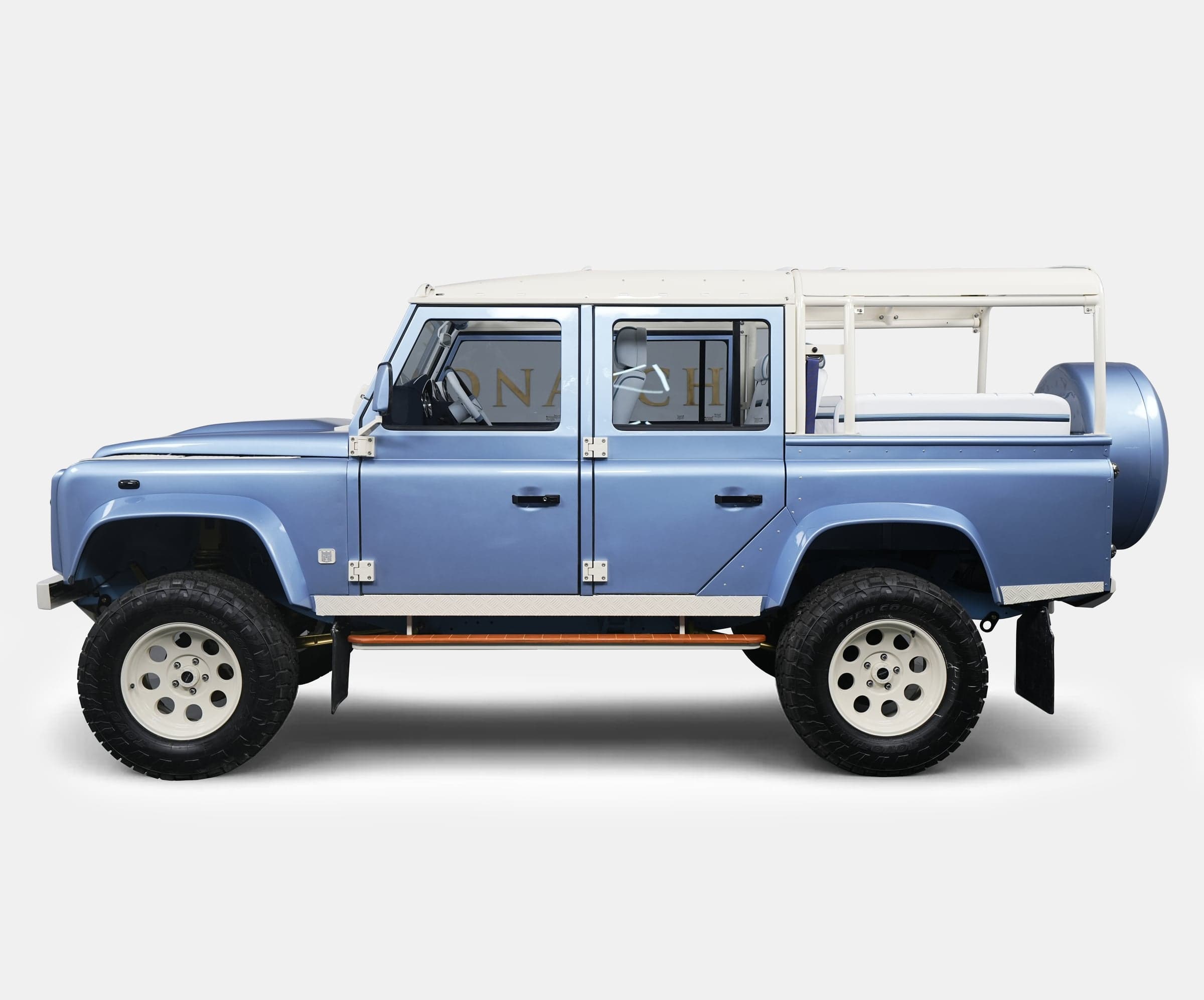 Side View: Bespoke Land Rover Defender Side view of a luxury custom Land Rover Defender in blue with white accents