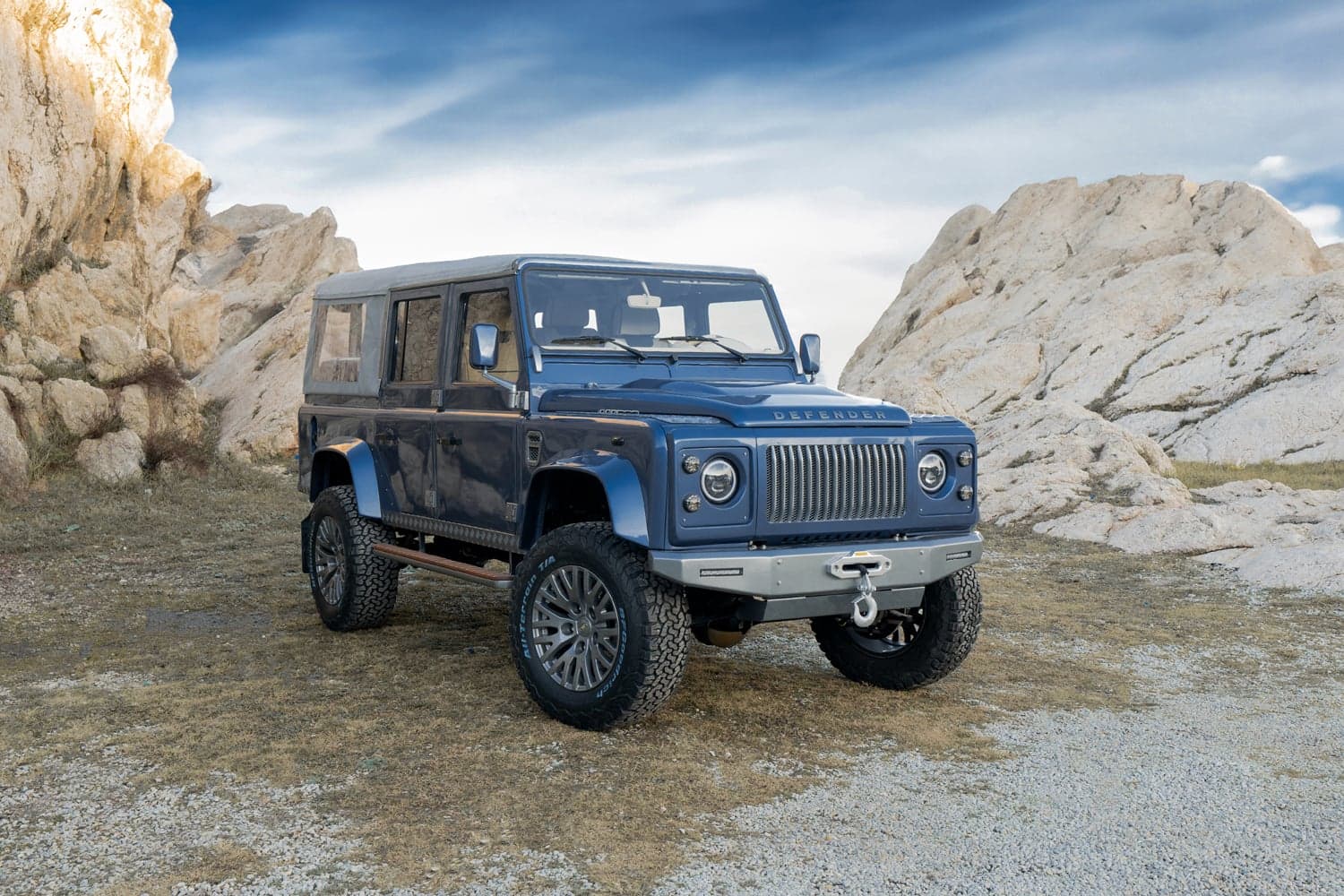 Studio Photo: Custom Land Rover Defender Custom blue Land Rover Defender parked on rocky terrain