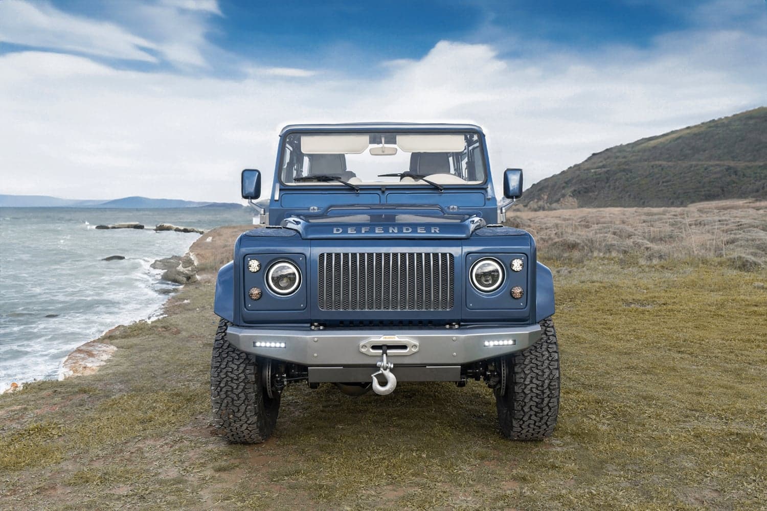 Front View: Bespoke Land Rover Defender Bespoke Land Rover Defender parked by the coast