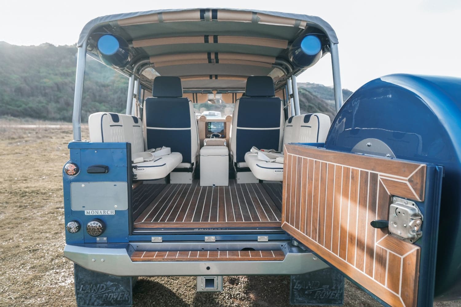 Interior Shot: Luxury Cabin Interior view of a bespoke Land Rover Defender showcasing premium seating and wooden flooring