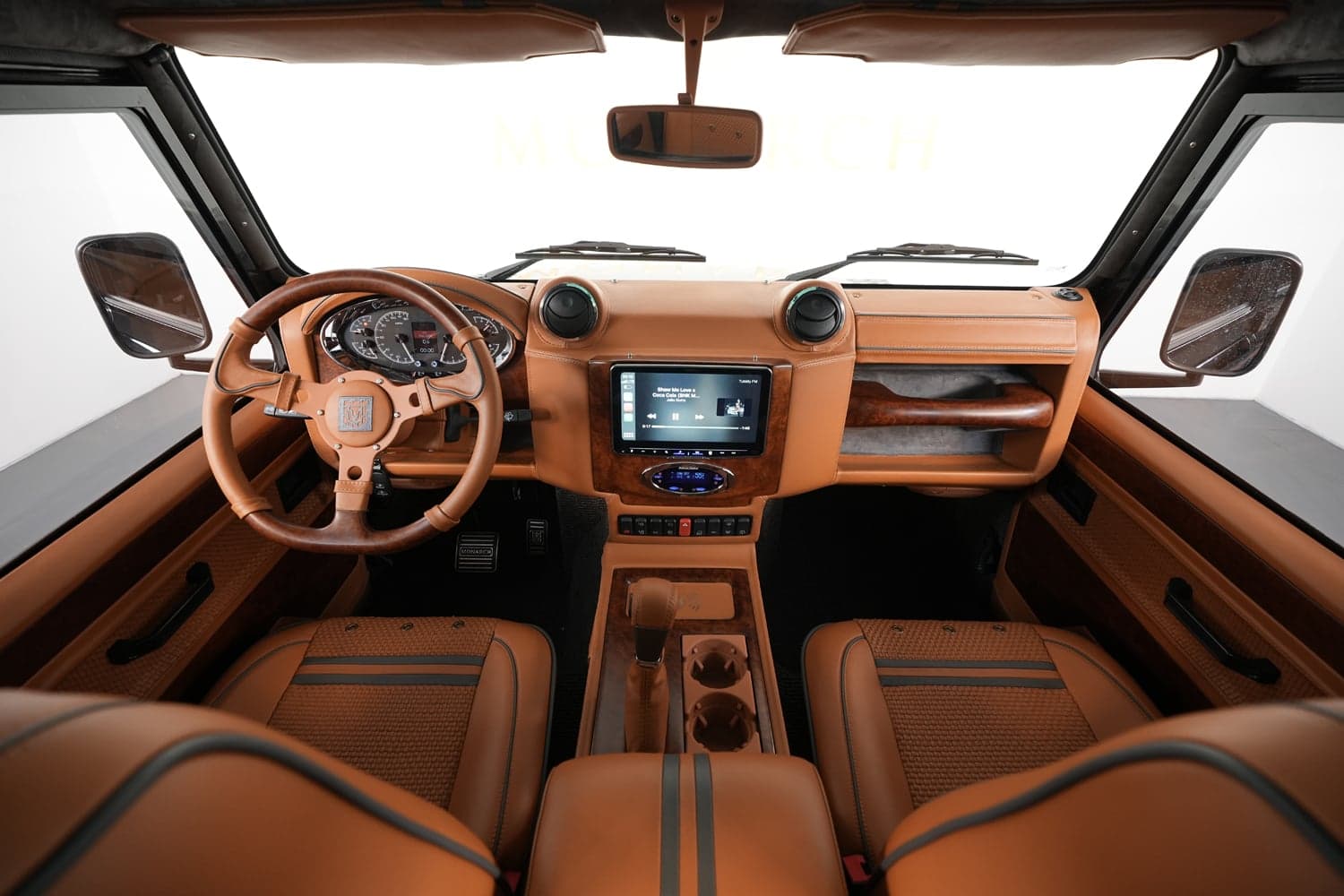 Interior Shot: Luxury Cabin Design Interior view of a custom Land Rover Defender showcasing premium leather seats and advanced technology