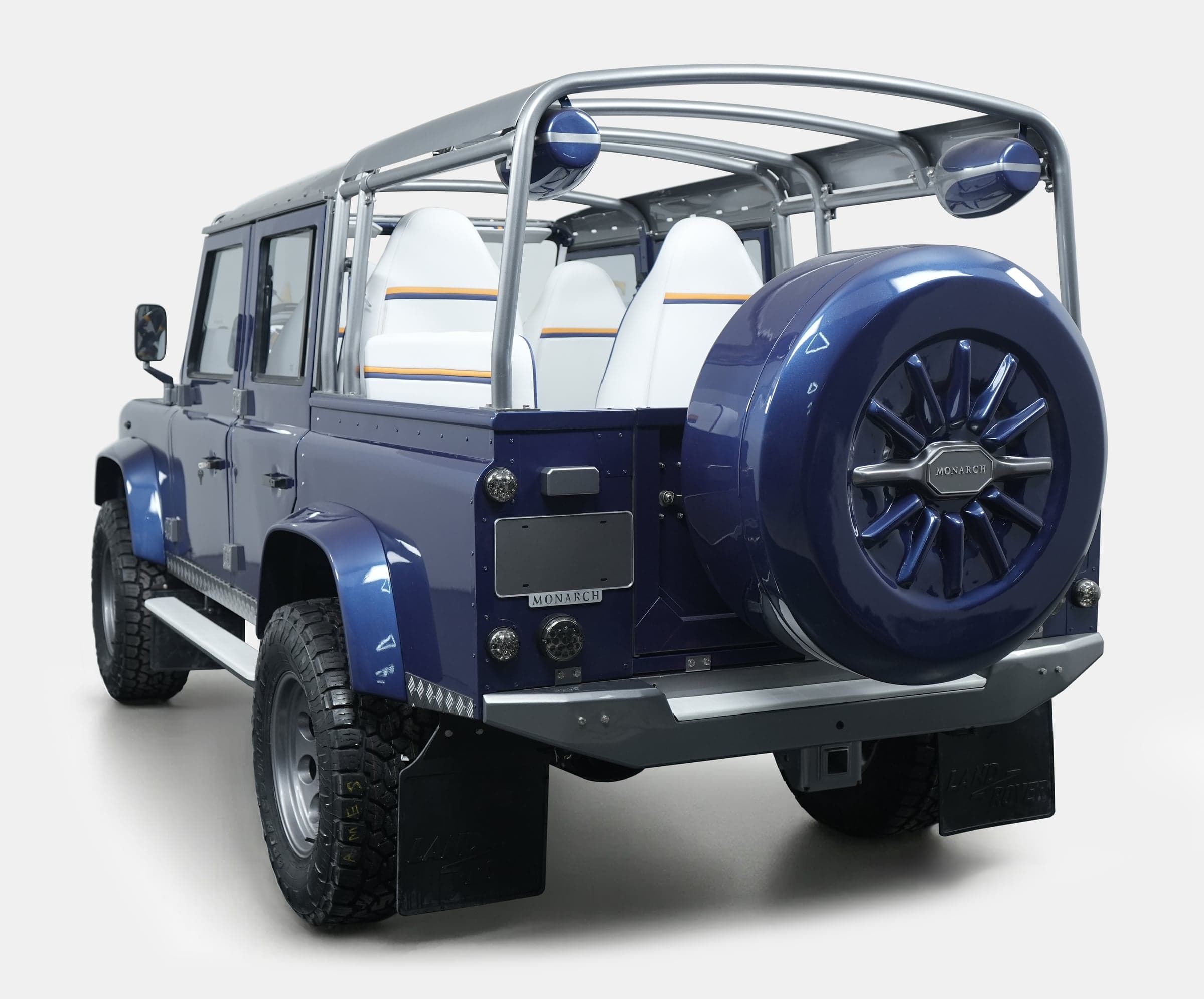 Rear View: Custom Land Rover Defender Rear view of a bespoke Land Rover Defender with a blue finish and premium seating