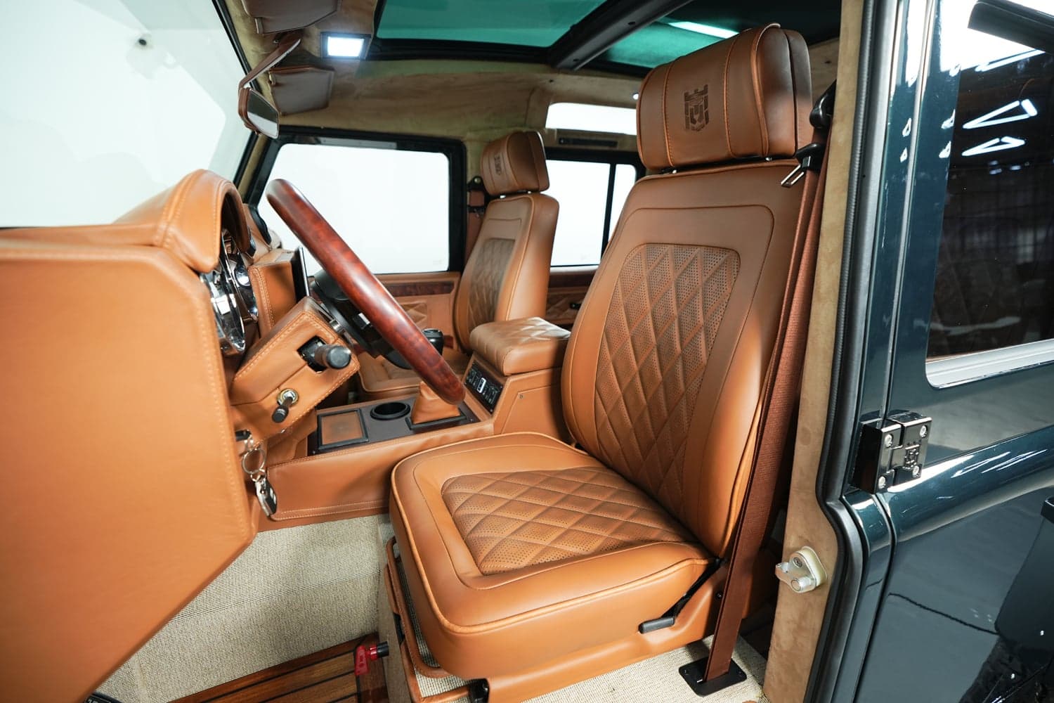 Interior Shot: Premium Leather Cabin Interior view of a luxury Land Rover Defender featuring tan leather seats and wood accents