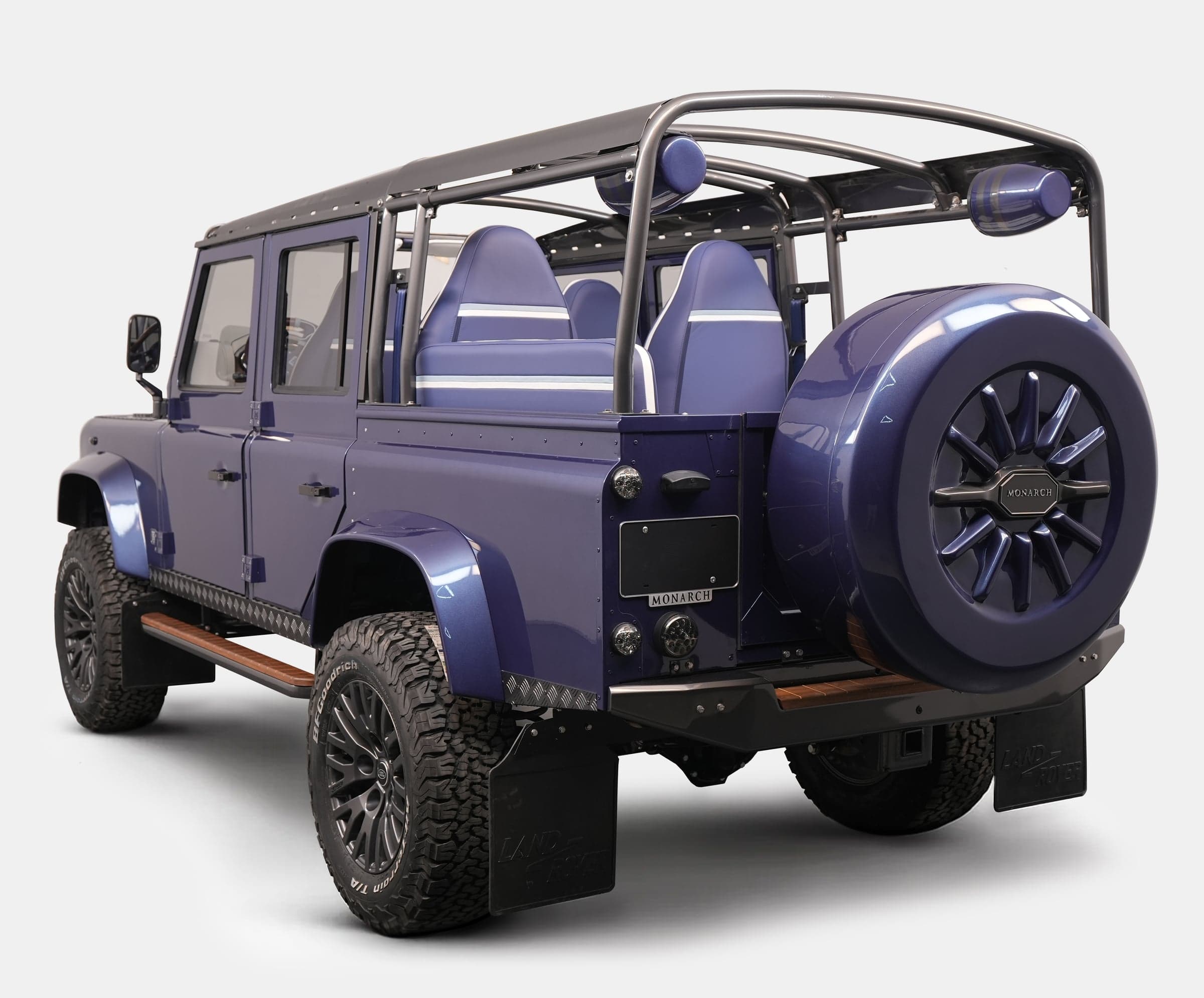 Rear View: Bespoke Land Rover Defender Bespoke Land Rover Defender in deep blue with custom seating and off-road tires