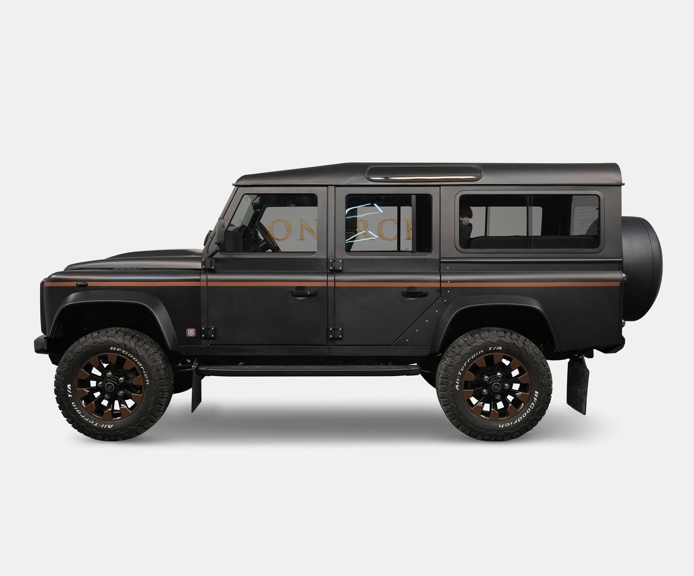 Side View: Custom Land Rover Defender Custom Land Rover Defender in matte black with bronze wheels