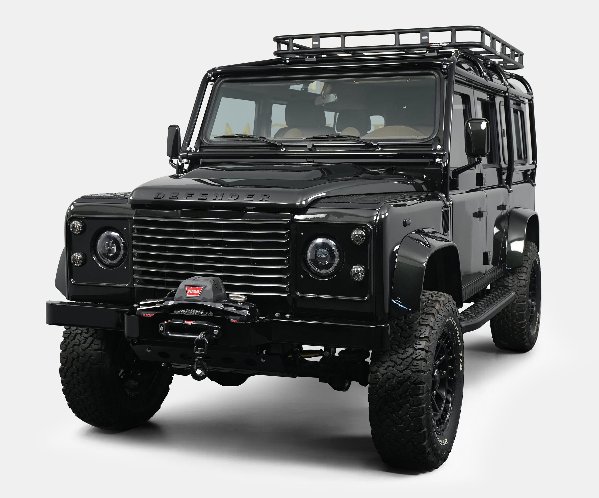 Front View: Custom Land Rover Defender Front view of a luxury custom Land Rover Defender with a black exterior and off-road features