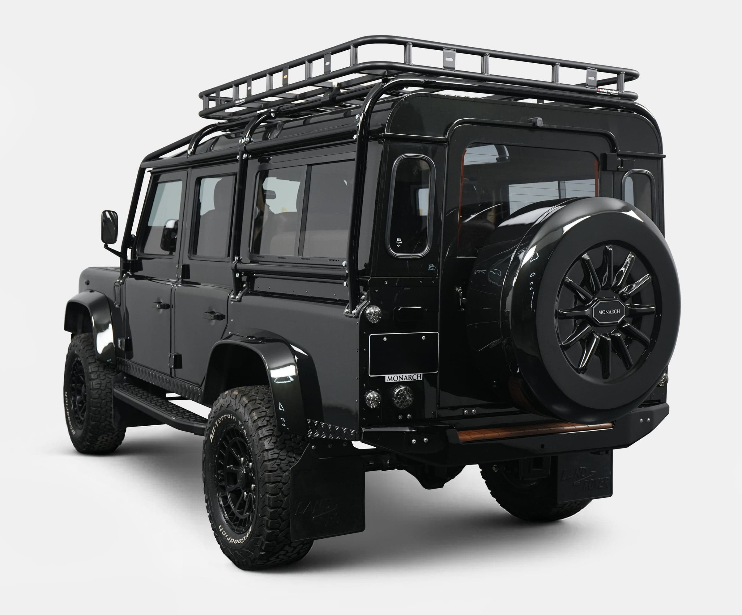 Rear View: Bespoke Land Rover Defender Black custom Land Rover Defender with roof rack and stylish rear design