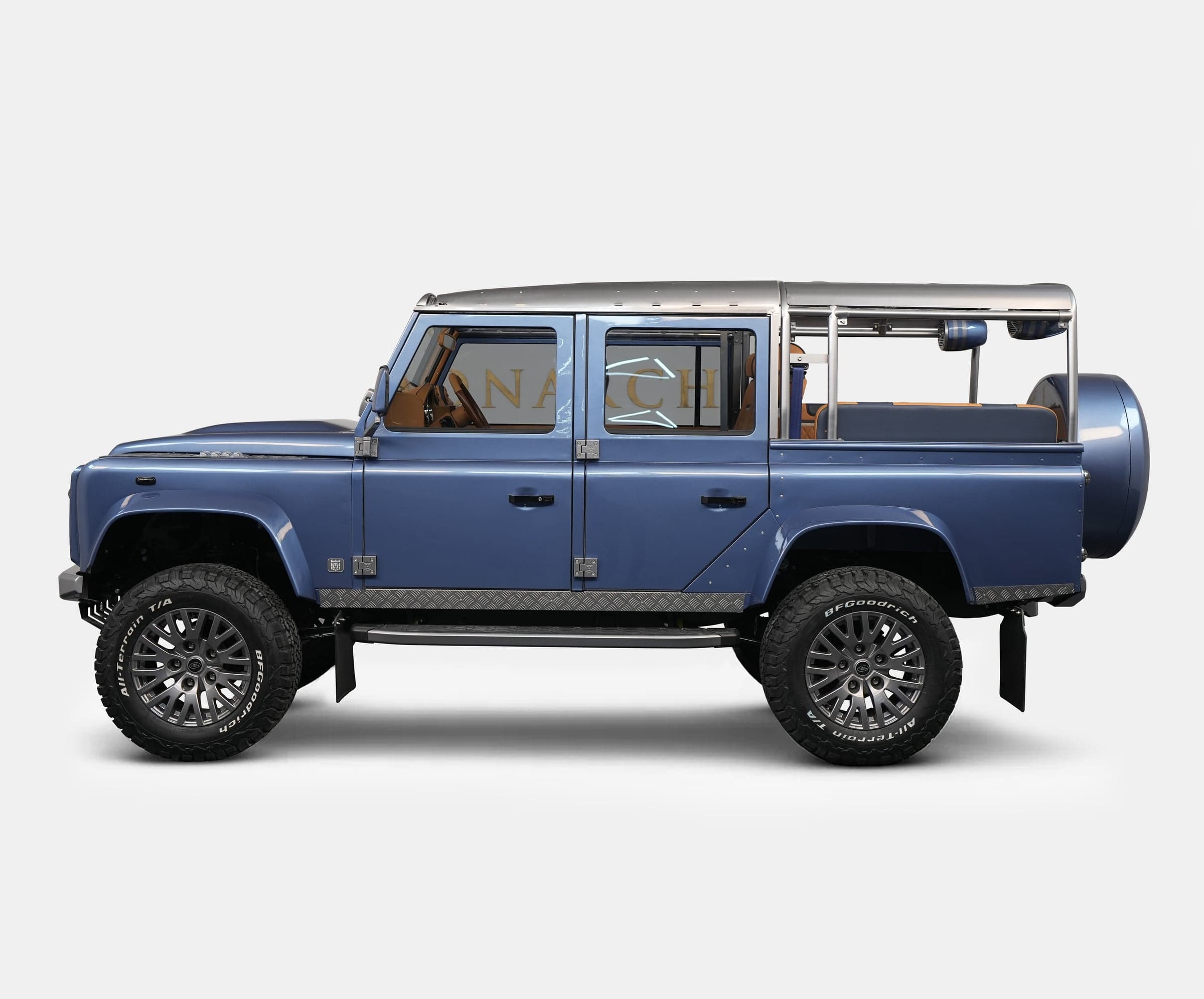 Side View: Custom Land Rover Defender Side view of a bespoke blue Land Rover Defender with luxury modifications