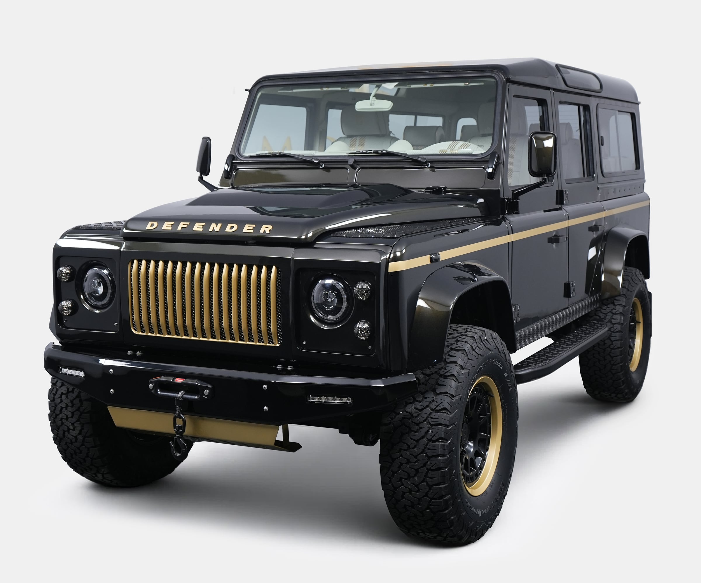 Front View: Bespoke Land Rover Defender Custom black Land Rover Defender with gold accents and bold grille