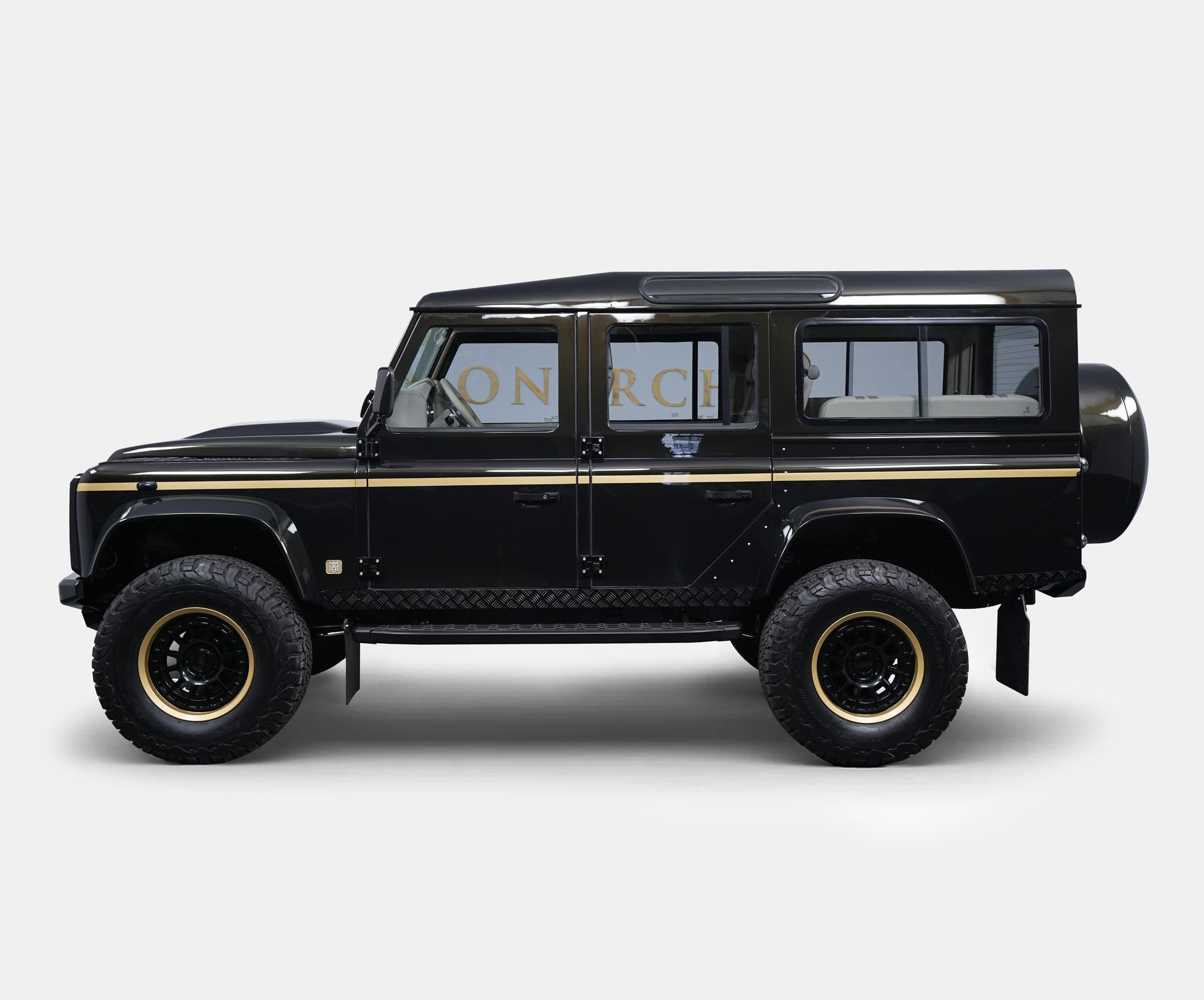 Side View: Bespoke Land Rover Defender Luxury custom Land Rover Defender in black with gold accents