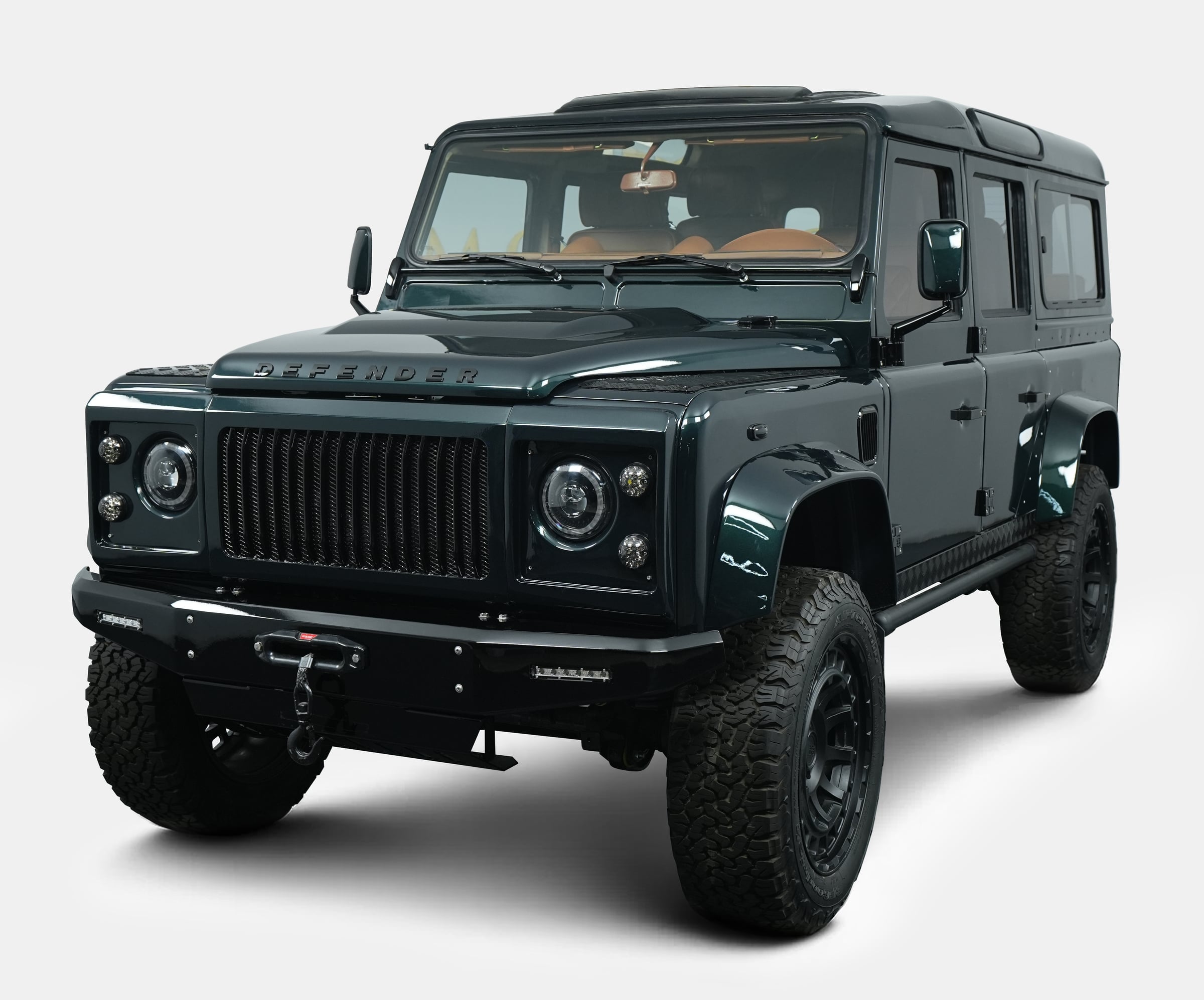Front View: Custom Land Rover Defender Bespoke Land Rover Defender in dark green with custom front grille and rugged tires