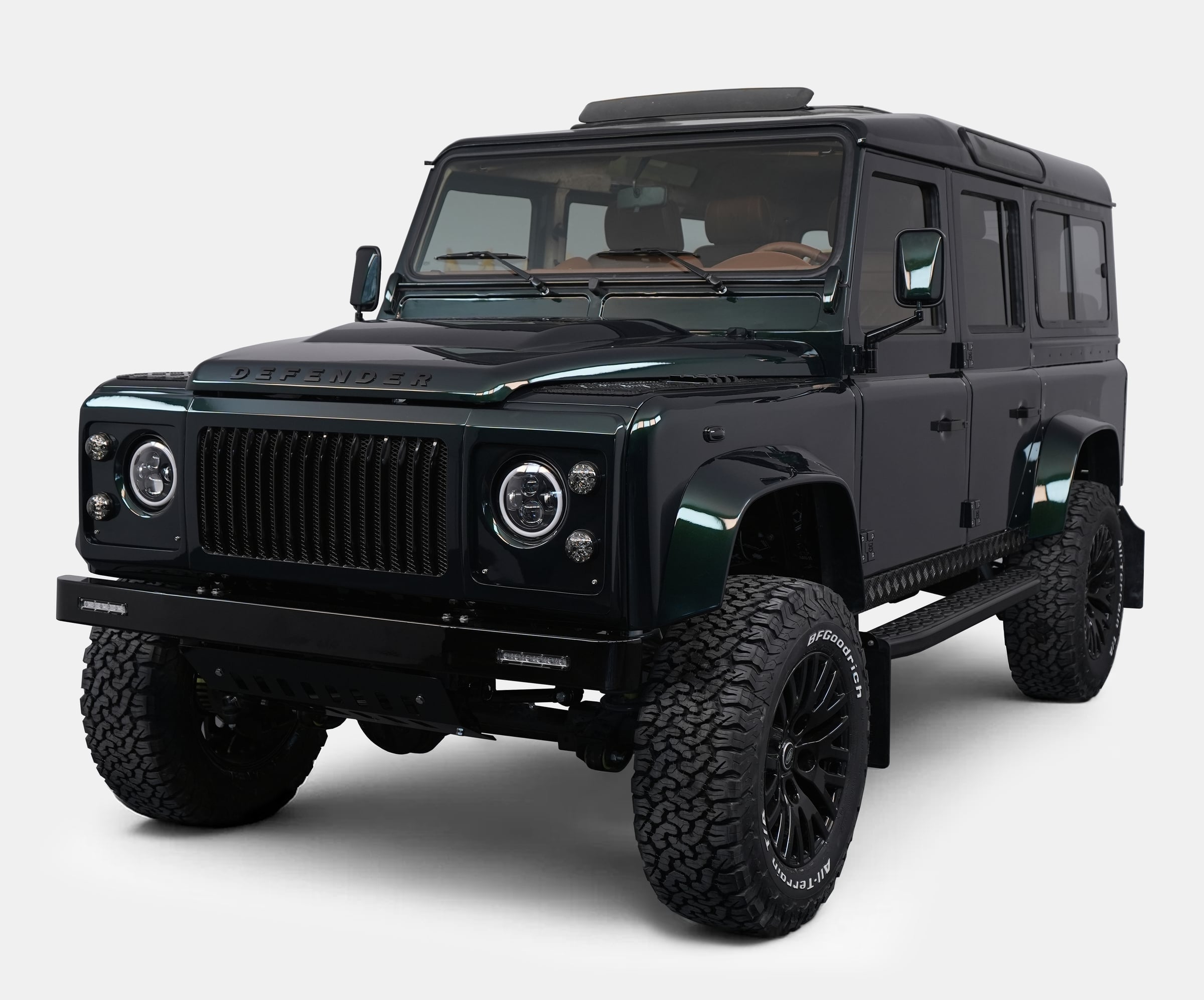 Front View: Bespoke Land Rover Defender Front view of a custom Land Rover Defender with a dark green finish and luxury design