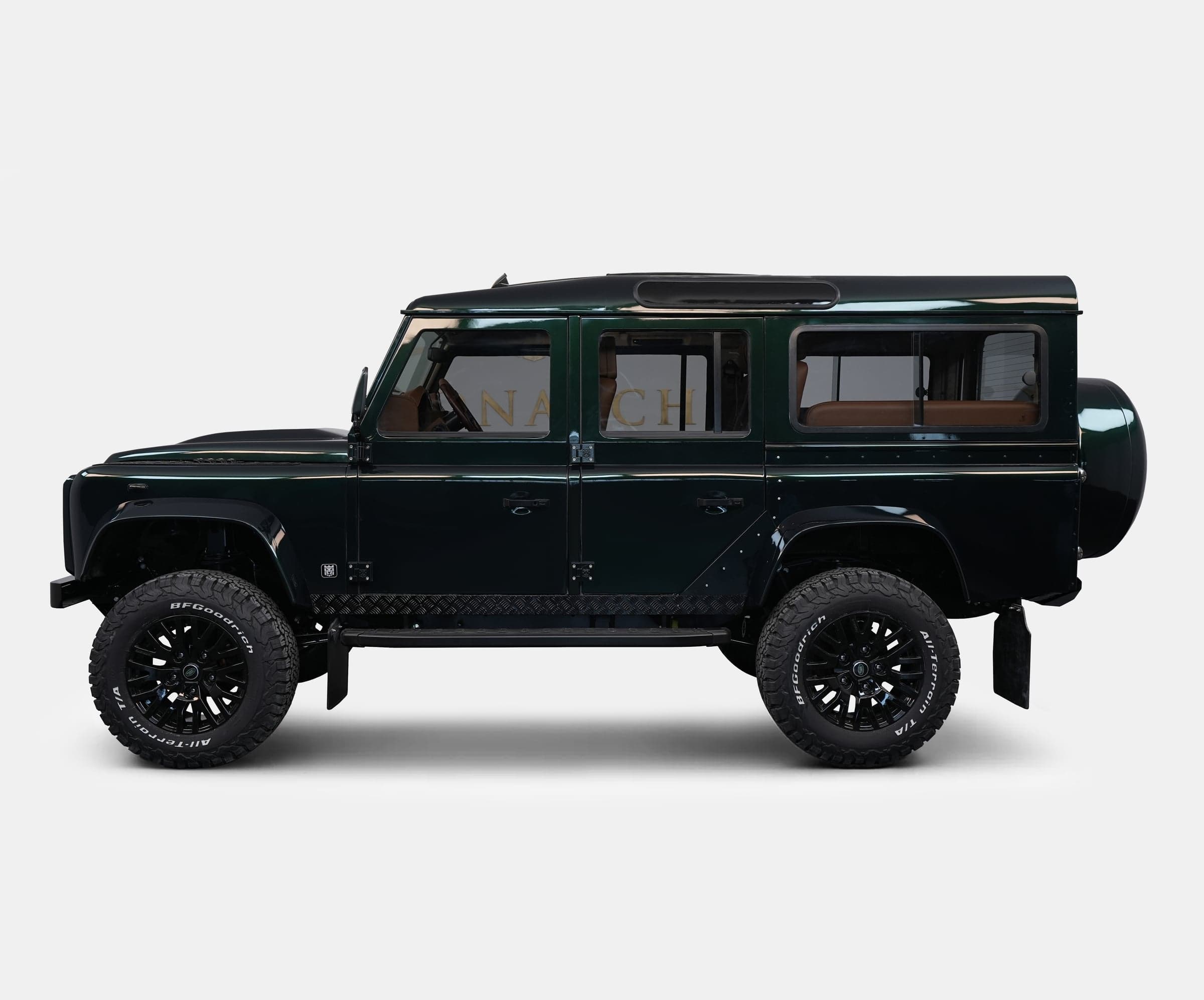 Side View: Custom Land Rover Defender Bespoke Land Rover Defender in dark green with black wheels