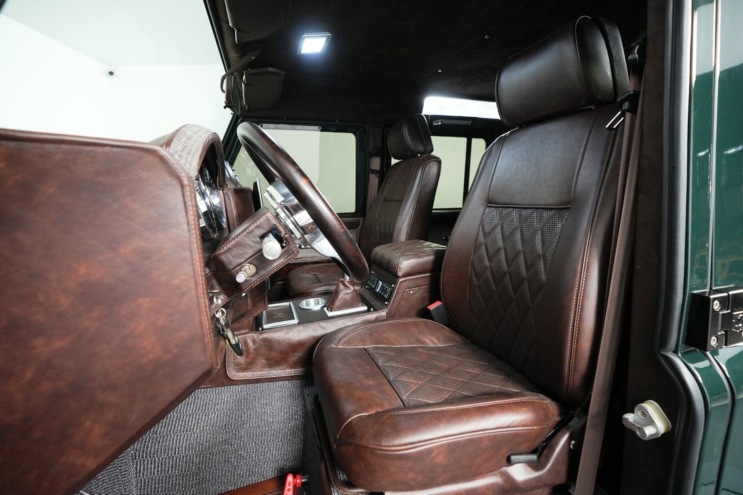 Interior Shot: Luxury Cabin Bespoke leather interior of a custom Land Rover Defender with detailed stitching