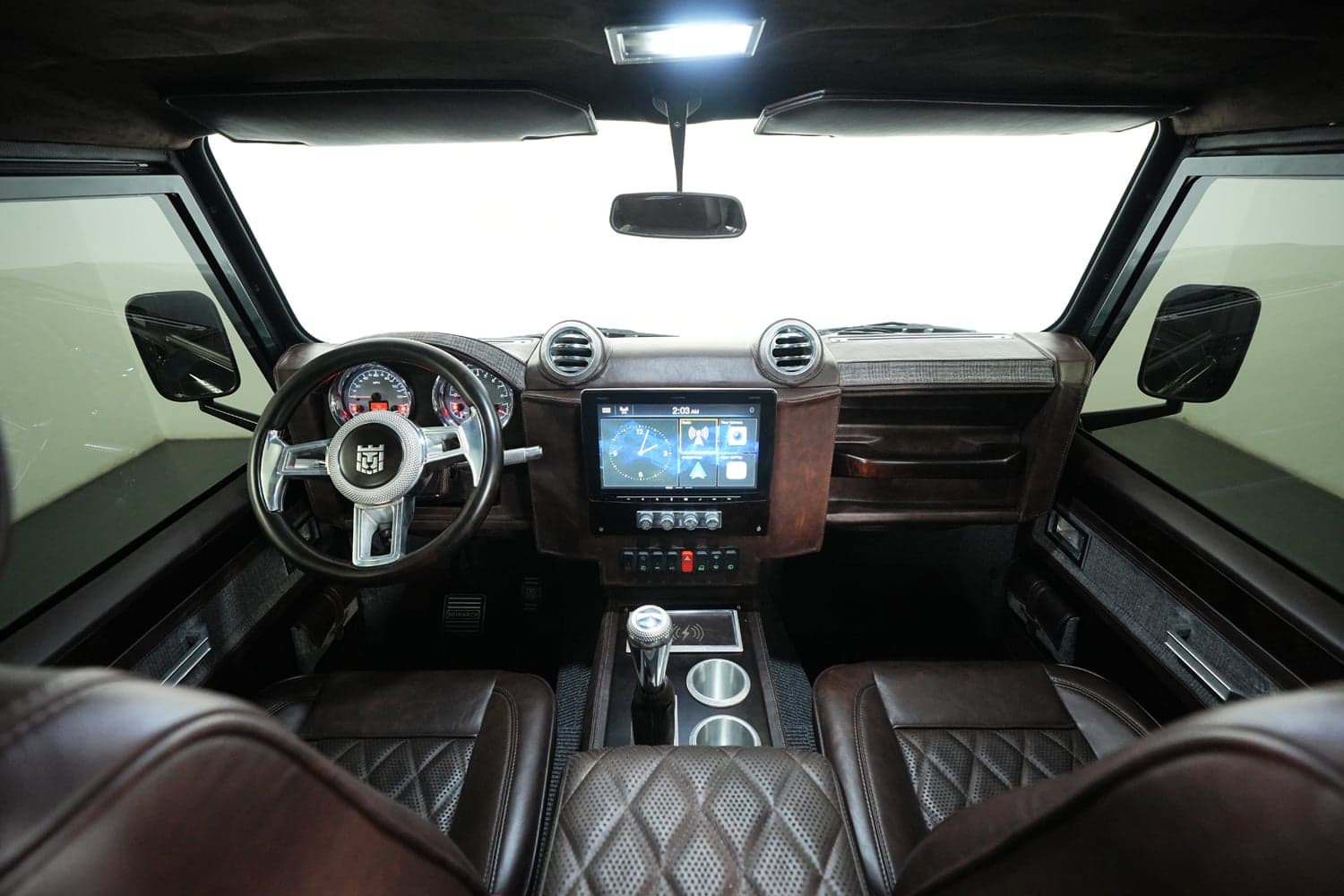 Interior Shot: Luxurious Cabin Interior view of a custom Land Rover Defender showcasing premium leather seats and advanced dashboard features