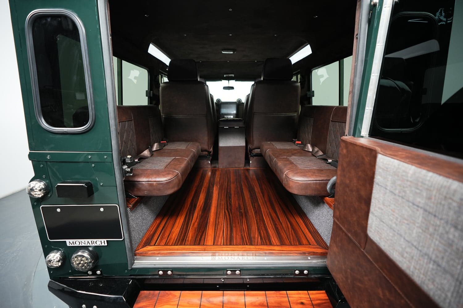 Interior Shot: Luxurious Cabin Interior view of a bespoke Land Rover Defender with premium leather seating and wooden flooring