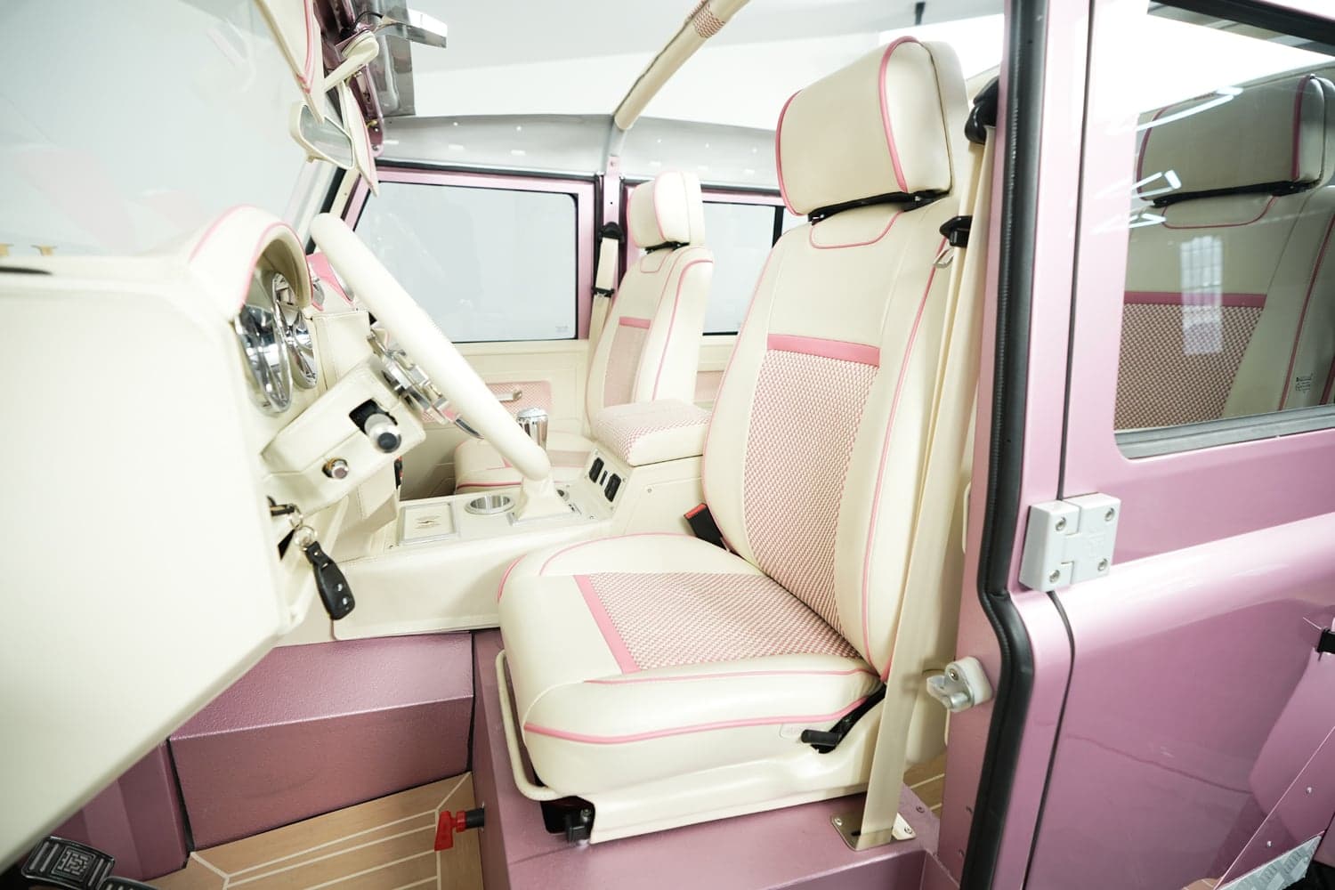 Interior Shot: Luxurious Cabin Design Interior of a bespoke Land Rover Defender with cream and pink leather seats