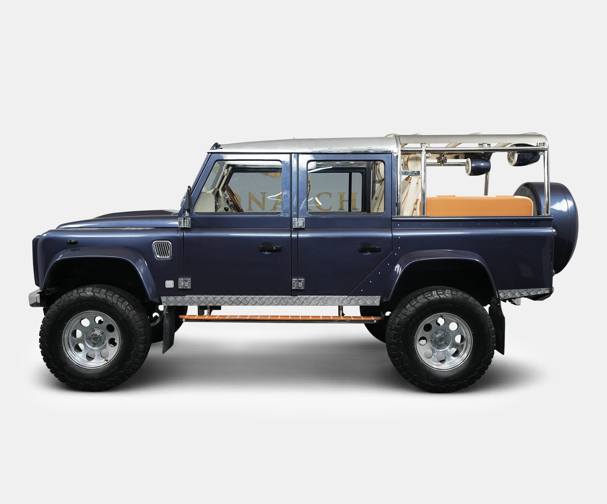 Side View: Bespoke Land Rover Defender Custom Land Rover Defender in dark blue with chrome accents