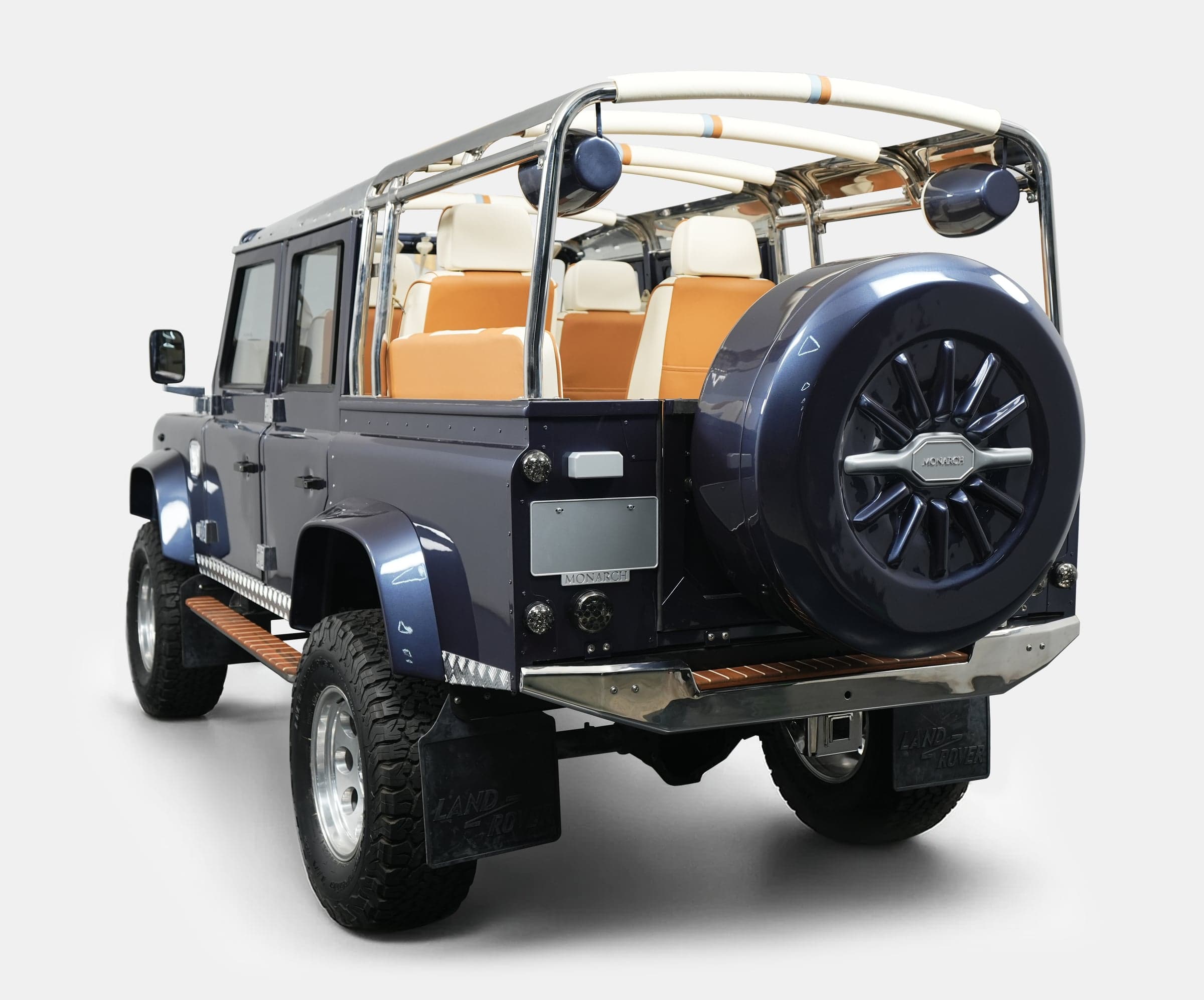 Rear View: Custom Land Rover Defender Custom Land Rover Defender in deep blue with beige interior and chrome accents