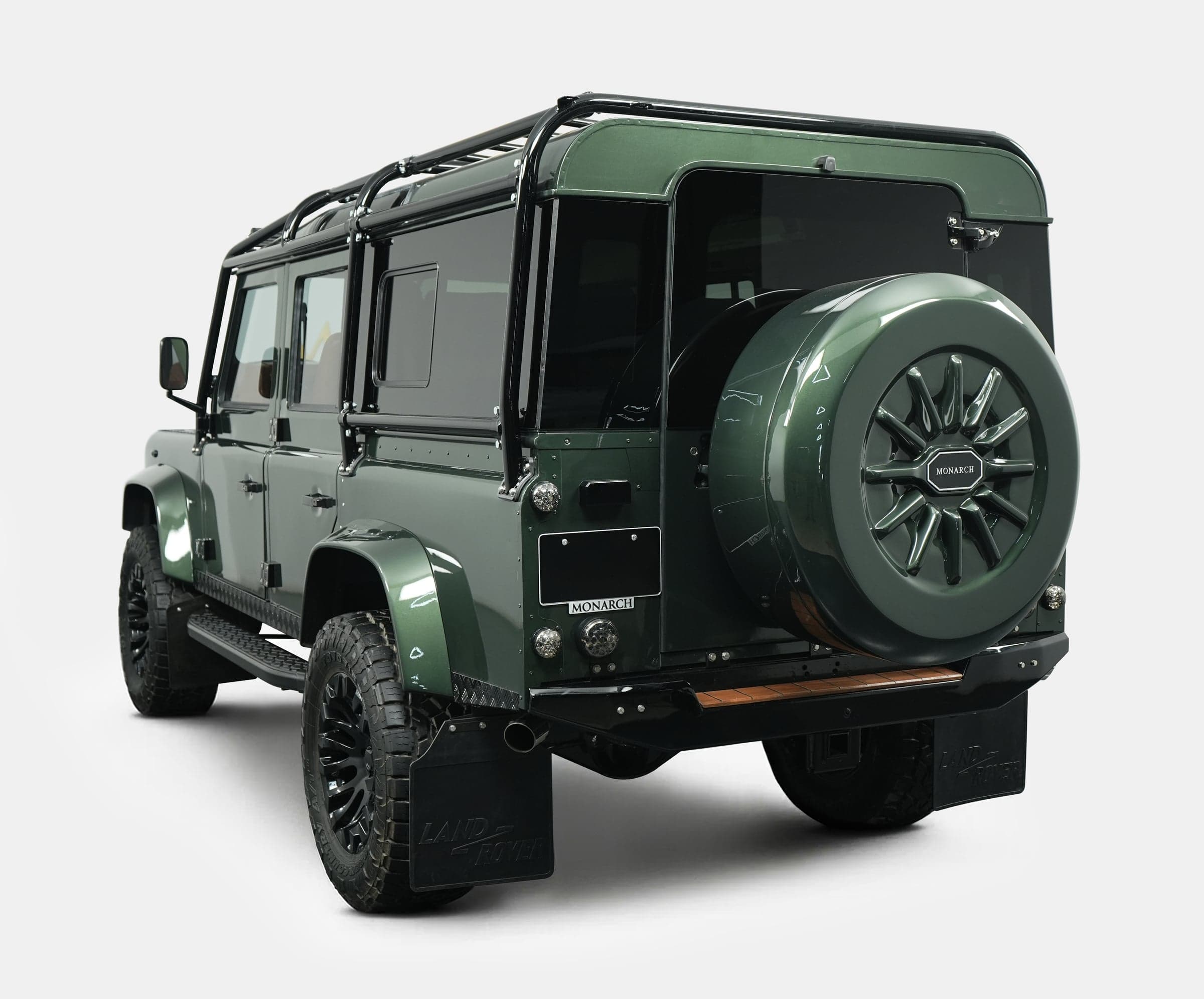 Rear View: Custom Land Rover Defender Rear view of a bespoke Land Rover Defender in deep green with custom features