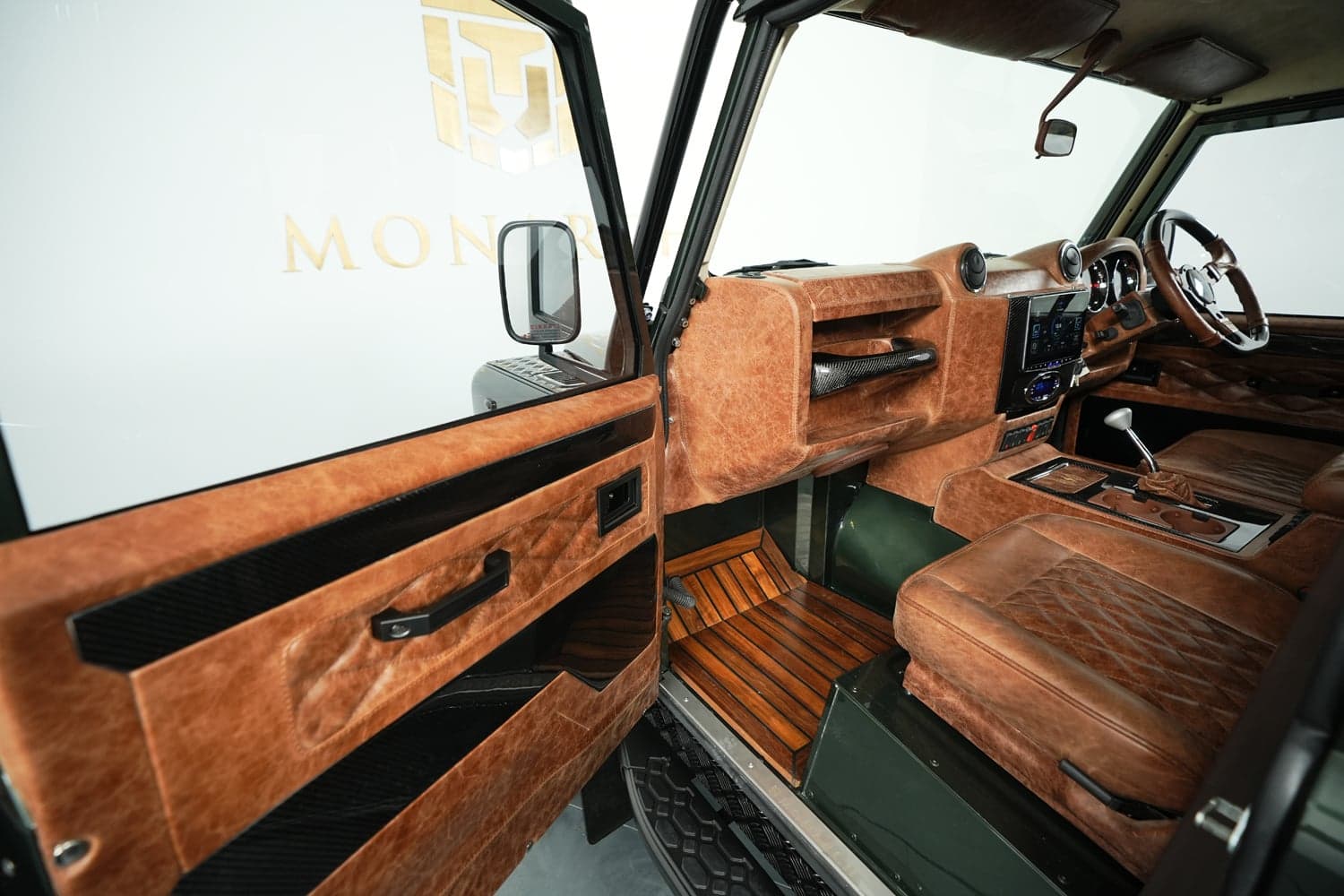 Interior Shot: Luxury Cabin Design Interior view of a bespoke Land Rover Defender showcasing premium leather and wood finishes