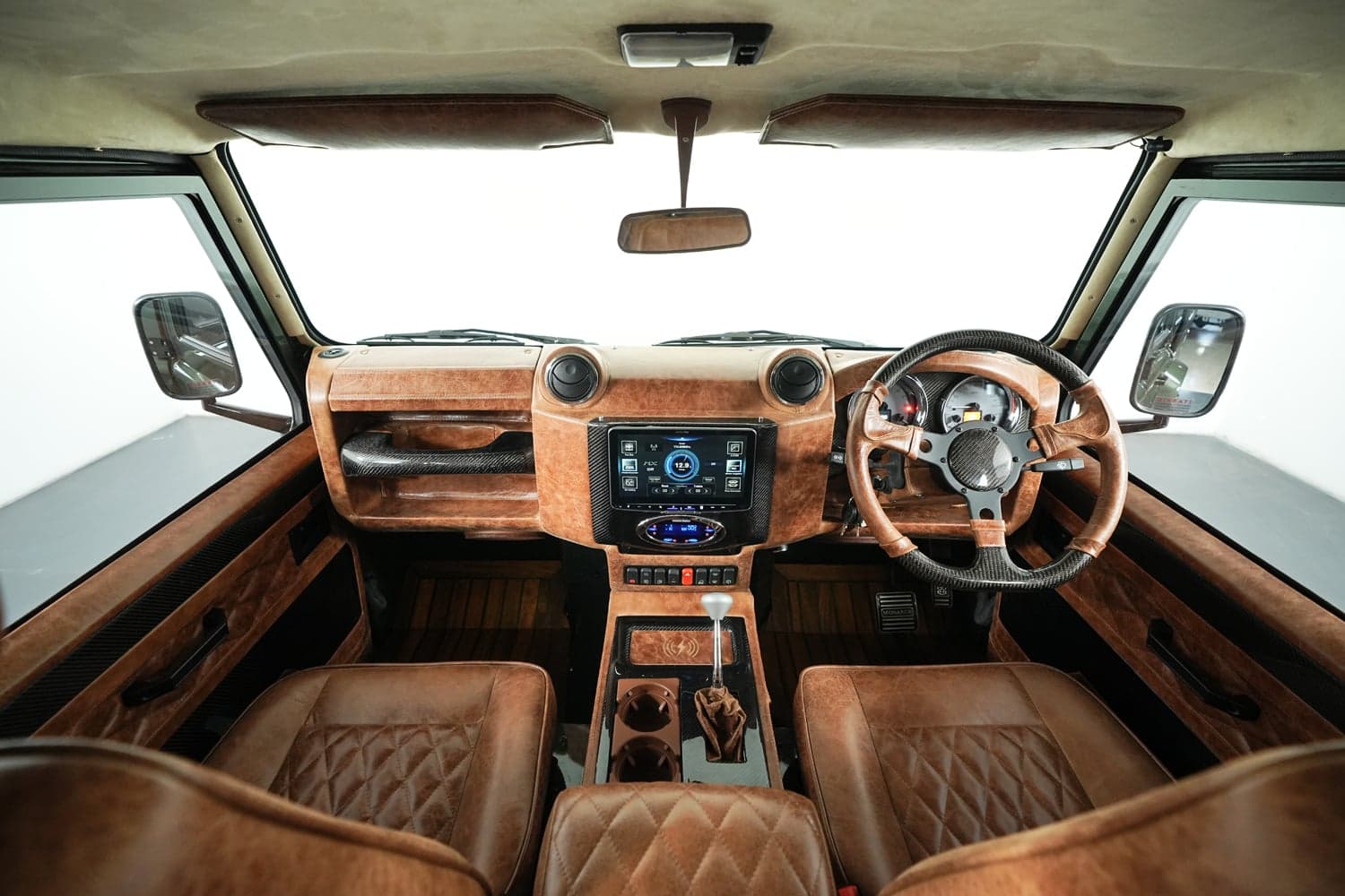 Interior Shot: Luxurious Cabin Design Bespoke Land Rover Defender interior featuring premium leather seats and advanced dashboard